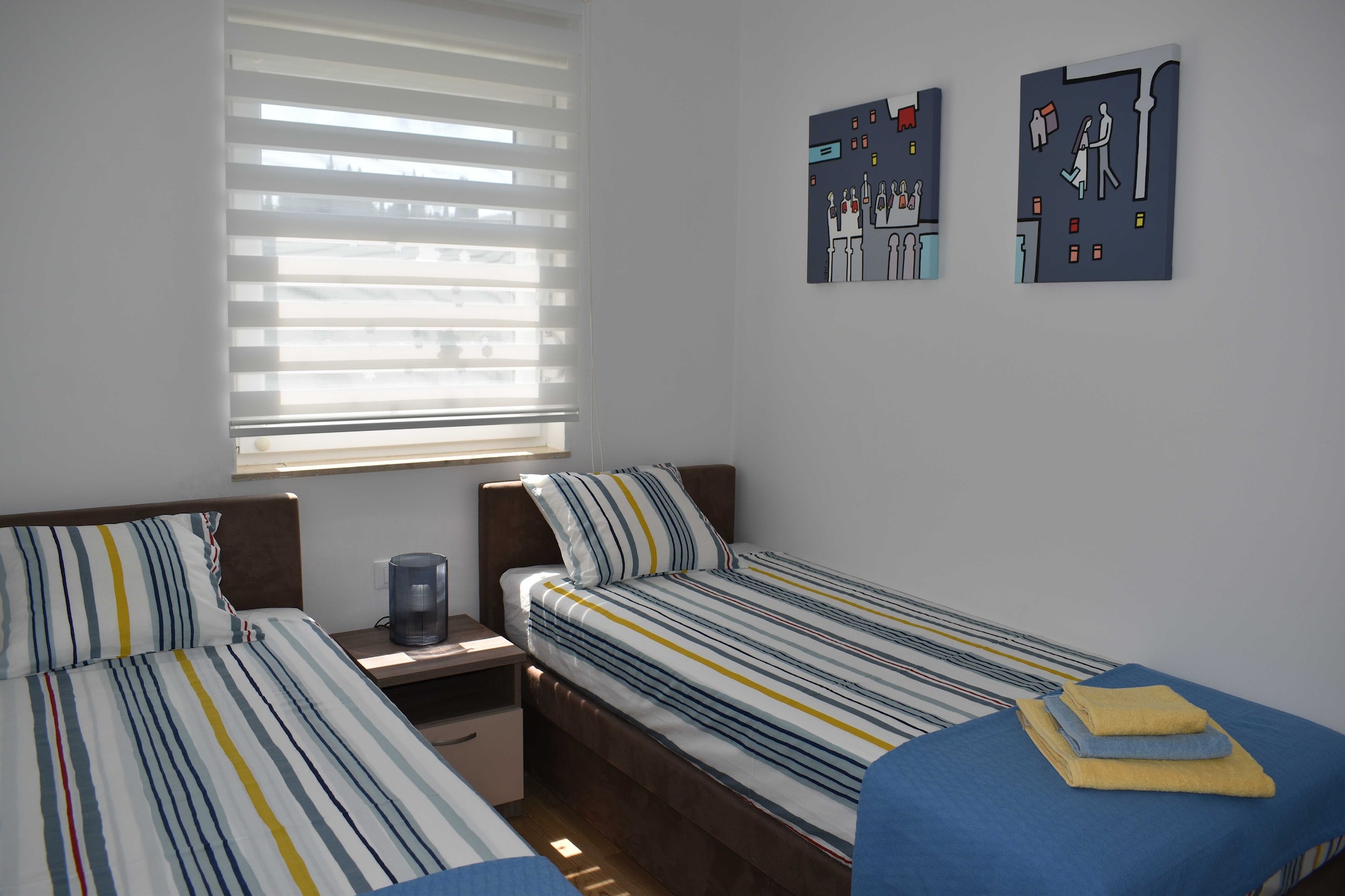 Ground floor: (Living room(TV, dining table, seating area), Kitchen(stove, electric kettle, toaster, oven, dishwasher, fridge, freezer), bedroom(double bed), bedroom(2x single bed), bathroom(toilet, shower))\n\nwashing machine, balcony, air conditioning, garden, parking, ironing board, iron, hairdryer