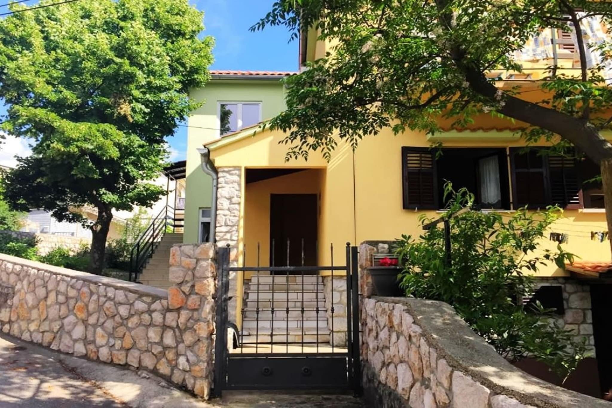 mezzanine: (Living room(TV, dining table, seating area), open kitchen(hob, electric kettle, hood, fridge, washbasin), bedroom(double bed), bedroom(single bed, single bed), bathroom(shower, washbasin, toilet), air conditioning)\n\nbalcony or terrace, parking