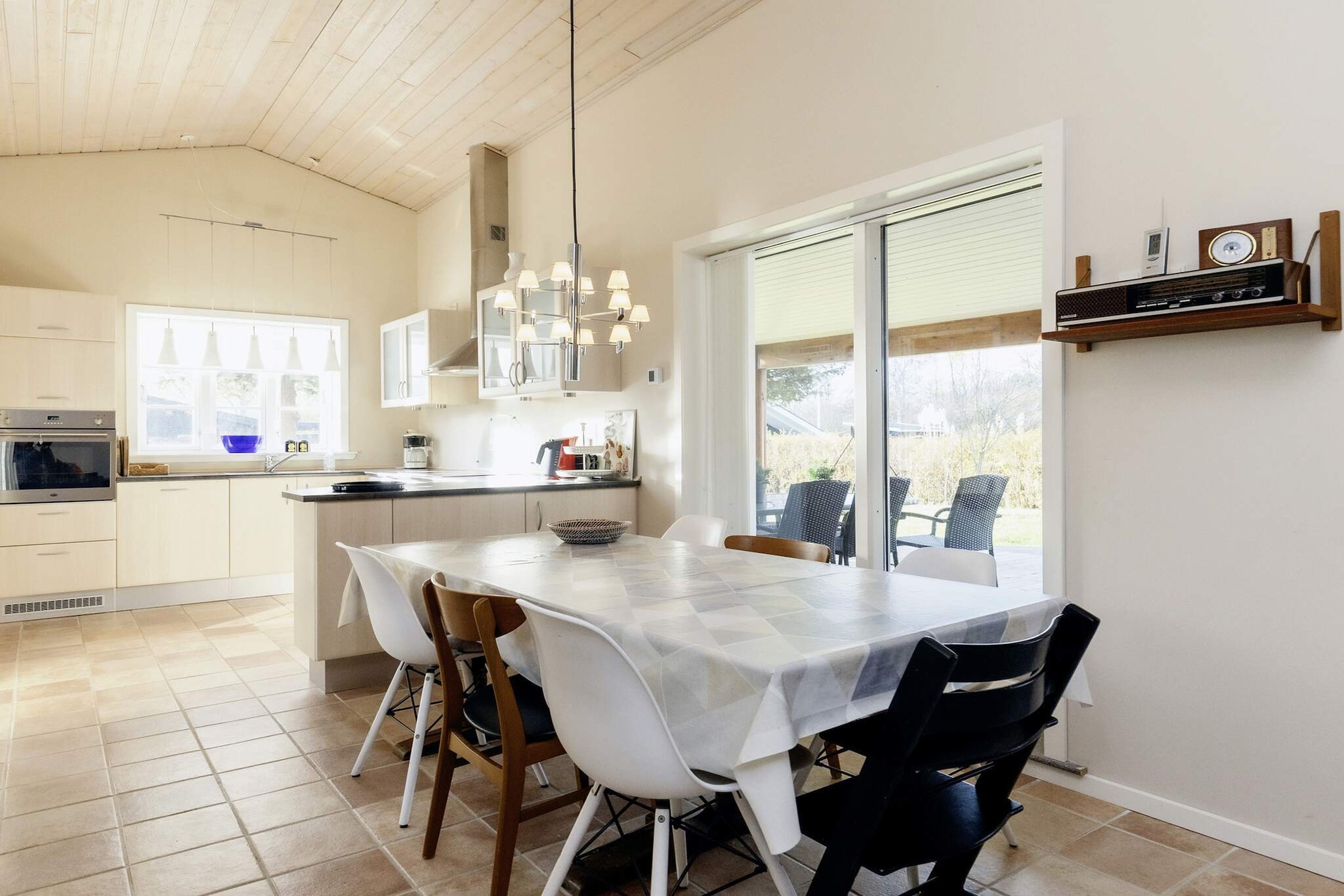 Kitchen(cooker(electric), hood, coffee machine, microwave, dishwasher, fridge-freezer), Living/bed room(double folding bed, TV, DVD player, high chair), bedroom(double bed, cot), bedroom(2x bunk bed), bathroom(floor heating)(washbasin, shower, toilet, washing machine), radio, terrace, garden, garden furniture, play equipment