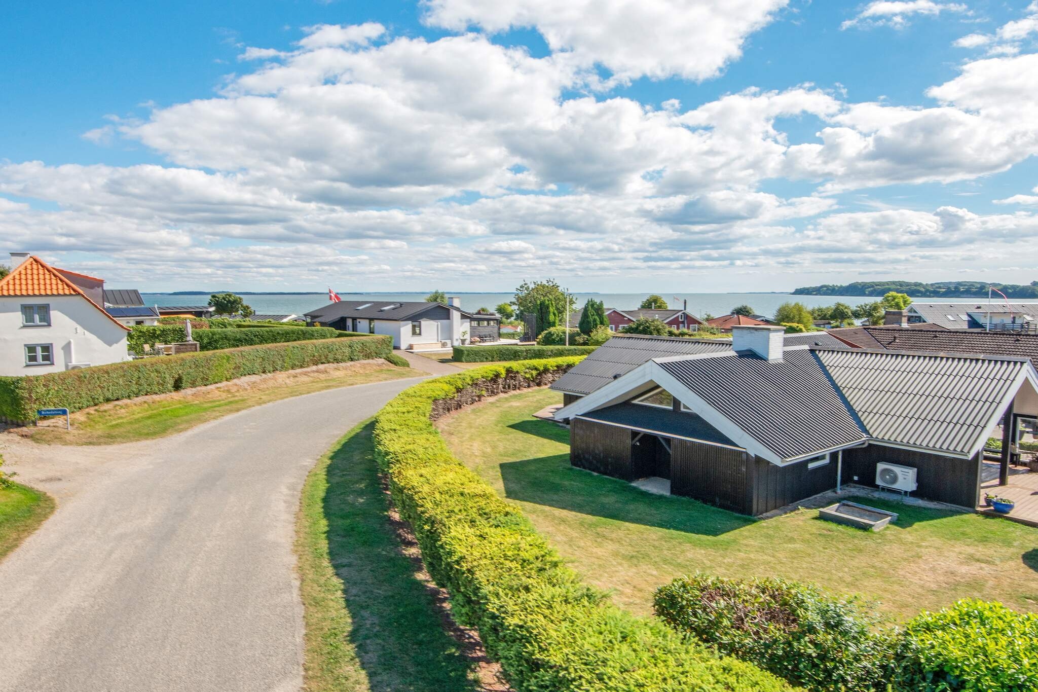 At Hejlsminde, you will find this vacation home with a hot tub. The vacation home was completely renovated in 2016, everything down to the foundation has been replaced and is new, and the house thus appears brand new. The bright and spacious house has two large bedrooms with double beds and one room with a bunk bed. There is an additional pull-out bed under the bunk bed, so there is room for up to seven people. You get a large kitchen/family room, which has a modern and very special, cozy style. There is plenty of space and wonderful light from both the large windows in the kitchen and the living area by the sofa. In the bathroom, you will find the house's wellness area in the form of a luxurious spa bath. In addition, the house is equipped with all conceivable amenities such as a washing machine, dryer, dishwasher, and heat pump, which can also cool on hot days. Outside, you will find several large terraces with plenty of garden furniture, including 4 sun loungers, play equipment for the children, and an outdoor shower with cold and hot water. There is also an outdoor kitchen and both gas and charcoal grills. There is a total of approx. 80 m2 of terrace, of which approx. 12 m2 is covered. After a fishing trip, you can prepare your catch on the fish cleaning station outside. Through a gate in the back garden, you are only about 50 m from the beach. The beach in Hejlsminde is known for being very child-friendly, and with its white sand, it is very inviting for many wonderful hours. Don't forget the wonderful opportunity for long walks along the beach, for example, to the harbor, which offers both a marina and many small fishing boats. Not available for rental to youth groups.A refundable deposit might be charged closer to your check-in date. The security deposit ensures a smooth stay and covers any additional services or consumption charges.This deposit covers utilities consumed during your stay and any additional services that may be taken.The final amount will be adjusted based on actual meter readings, actual usage of extra services, and any remaining balance will be refunded within 21 days after checkout.This deposit simply acts as a prepayment for charges that  you would anyways pay for, ensuring a seamless stay and check-out experience.