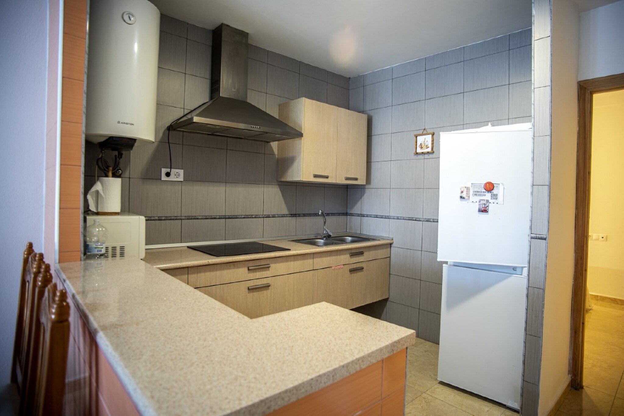 Ground floor: (Kitchenette(hob, coffee machine, microwave, fridge-freezer), Living/diningroom(TV, dining table, seating area), bedroom(double bed), bedroom(single bed), bathroom(shower, washbasin, toilet))\n\nstorage(washing machine), parking