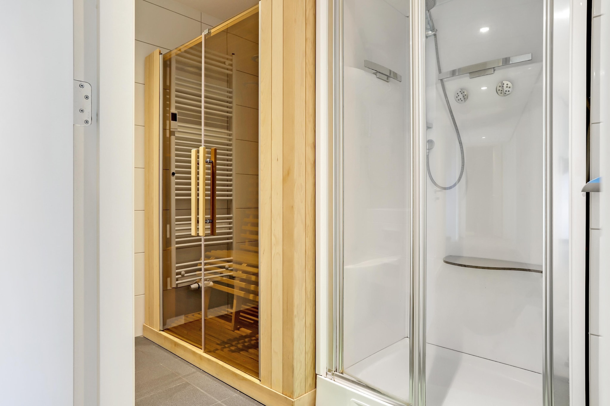 Ground floor: (Living room(double sofa bed, TV, fireplace, seating area, DVD player, party games), open kitchen(bar, hob(5 ring stoves, gas), electric kettle, coffee machine(filter), combination microwave, dishwasher, fridge, freezer), Bedroom with bathroom(single bed, single bed, shower, washbasin), Bedroom with bathroom(single bed, single bed, shower, washbasin))\n\nBasement: (bedroom(single bed, single bed), bedroom(single bed, single bed), bedroom(single bed, single bed), bedroom(single bed, single bed), bathroom(Bubble bath, washbasin), bathroom(massage shower, sauna, washbasin), toilet, playroom(double sofa bed, table tennis table, table football, darts, billiards))\n\ntumble dryer, cot, washing machine, terrace, garden(partially fenced), garden furniture, BBQ, high chair