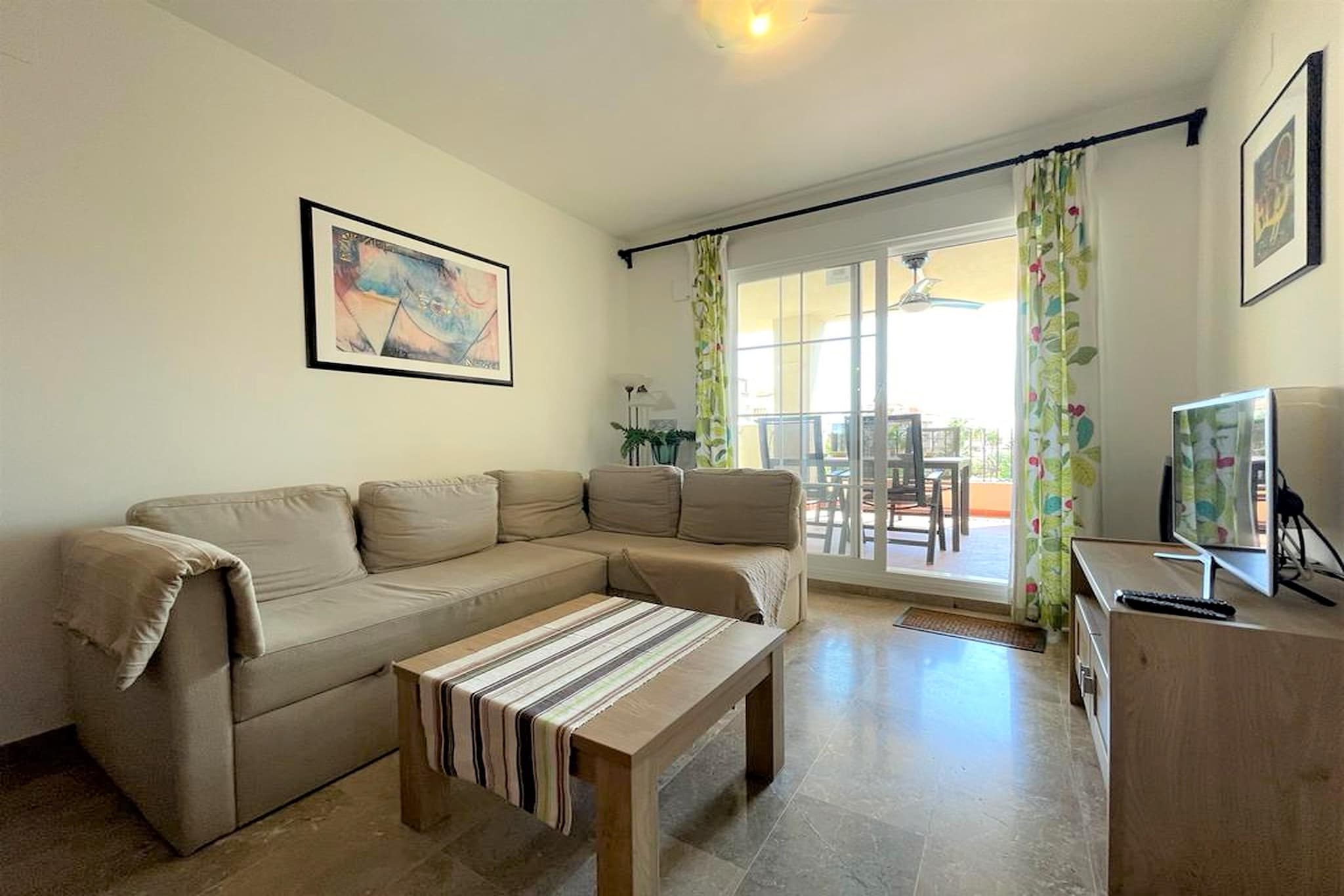 Set within the peaceful surroundings of Residential Vereda Golf, this inviting second-floor apartment offers the perfect blend of comfort, convenience and holiday atmosphere - ideal for families, couples or friends looking for a laid-back escape.

The interior opens into a bright and welcoming living space with a single sofa bed, television, dining table and comfortable seating, creating a relaxing hub for social moments and quiet evenings. The adjoining fully equipped kitchen makes home-style meals and relaxed breakfasts effortless. The apartment includes two comfortable bedrooms - a master bedroom with a double bed and a second bedroom with two single beds - ideal for children or friends. There are two modern bathrooms, one with a bathtub and shower combination, and another with a separate shower, ensuring privacy and smooth mornings. A dedicated laundry room with a washing machine provides added convenience for longer stays.

Extra comforts include air conditioning, air-to-air heat pump, lift access, and garage parking with shared entrance, creating an easy and comfortable stay from arrival to departure.

Outside, your private 15 m² terrace is furnished for outdoor dining and lounging, with direct access to the shared illuminated garden - a peaceful green setting dotted with seating areas and hammocks. The outdoor swimming pool offers refreshing relief on sunny days, while shared fitness equipment allows you to stay active throughout your stay.

This apartment delivers a relaxed resort lifestyle with all the comforts of home - an effortless base for enjoying sunshine, rest and quality time together.