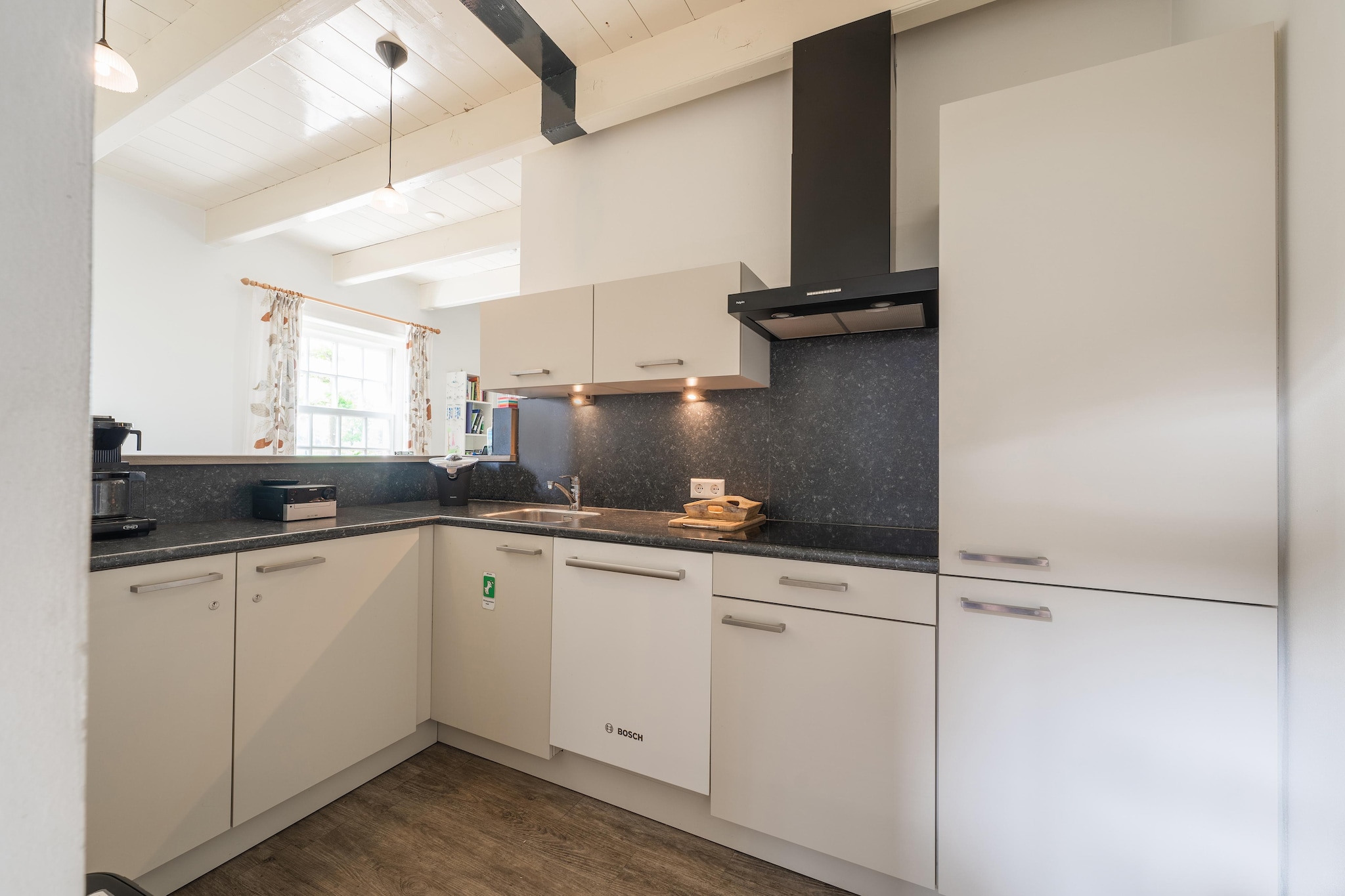 Ground floor: (Entrance, hall, Living room(TV, dining table, seating area, party games), open kitchen(dining table(12 persons), electric kettle, cooker(ceramic), hood, coffee machine(filter), microwave, dishwasher, fridge), bedroom(double bed or 2 single beds(boxspring), TV, seating area), bedroom(double bed or 2 single beds(boxspring), TV, seating area), bedroom(double bed or 2 single beds(boxspring), TV, seating area), bedroom(double bed or 2 single beds(boxspring)), bedroom(single bed, single bed, TV, seating area), bedroom(single bed, single bed, TV, seating area), bathroom(shower, washbasin, toilet), bathroom(shower, washbasin, toilet), bathroom(shower, washbasin, toilet), bathroom(shower, washbasin, toilet), bathroom(shower, washbasin, toilet), bathroom(shower, washbasin, toilet), toilet(washbasin, toilet))\n\nheating(central), garden(partially fenced), garden furniture(12 persons), BBQ, parking, hammock