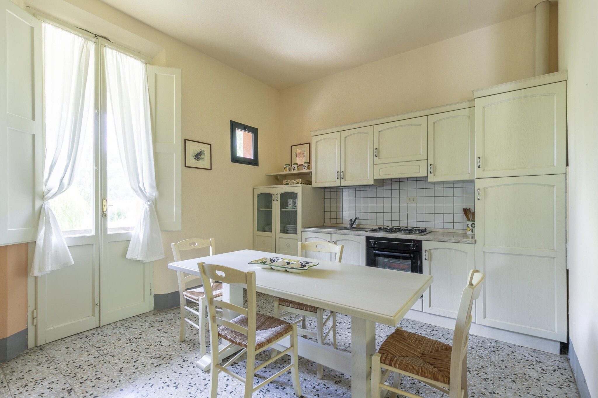 A Relaxing Stay in Montopoli Valdarno
Located in the heart of Tuscany, this inviting holiday home offers a peaceful retreat for guests looking to immerse themselves in the regionâ€™s stunning countryside. Surrounded by rolling hills and lush greenery, the property provides a warm and authentic Tuscan experience. Its spacious interior and charming garden make it an ideal destination for both relaxation and exploration, while nearby villages offer a glimpse into local culture and traditions.

Well-Appointed Spaces for a Relaxing Stay
Designed for convenience, the home features two well-equipped kitchens, each with modern appliances including an oven, coffee machine, and fridge-freezer. The living and dining areas provide a welcoming space to unwind, complete with satellite TVs for entertainment. Four bedrooms offer restful accommodations, complemented by three bathrooms with showers, washbasins, toilets, and bidets. Outside, guests can enjoy the private garden, furnished with seating, a BBQ, and access to a shared swimming pool (open from May to September), perfect for sunny afternoons.

Uncover Tuscanyâ€™s Heritage & Flavors
Perfectly positioned for exploring Tuscanyâ€™s iconic destinations, the home is a short journey from Lucca (65 km) and Florence (43 km), each rich with history, art, and architecture. The nearby village of Le Capanne, just 5 km away, offers essential amenities, including bakeries, restaurants, and local shops. For those looking to relax on the coast, Tirreniaâ€™s sandy beaches lie 73 km away. Whether savoring Tuscan cuisine or discovering hidden gems, this charming retreat promises an unforgettable experience in the heart of Italy.