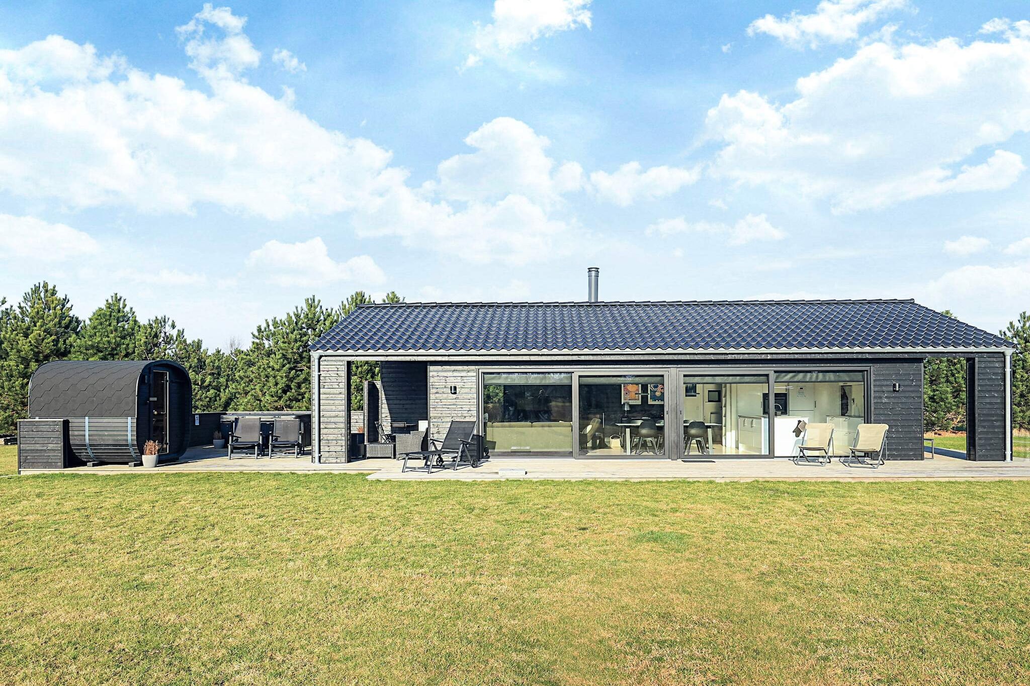 Luxurious Holiday Home in Marielyst – Outdoor Wellness with Sauna and Heated Spa NOTE: The outdoor spa is closed from December to February due to frost. Welcome to this newly built and exclusive holiday home from 2023, where luxury, comfort and scenic surroundings come together in a higher unity. Here you will find the ideal setting for an unforgettable holiday - all year round. The holiday home is located just a 15-minute walk or 3-minute drive from one of Denmark's most beautiful and child-friendly beaches in Marielyst. Wellness under the open sky Outdoors, your very own private wellness area awaits you with an electric sauna for four people and a spacious spa, heated to a comfortable 38 degrees (open March–November). From May to October, there is also access to an outdoor shower – perfect after a dip in the sea or a day in the sun. Stylish interior & modern facilities Inside, the house offers a bright and open kitchen-dining room with all modern facilities: dishwasher, oven, microwave and coffee maker. In the living room, you can relax in comfortable furniture in front of a smart TV with streaming services, enjoy the crackling wood-burning stove and use free Wi-Fi. The house is also child-friendly with a high chair, travel cot and a selection of board games. Space for the whole family The cottage has three bedrooms: Two rooms with single beds (can be joined to make double beds) One room with double bed and bunk bed A loft with two extra sleeping spaces – ideal for children and young people One of the rooms is equipped with a games console and TV, while another has a dart board - perfect for both relaxation and entertainment. There are two modern bathrooms with showers and underfloor heating, and the house has both a washing machine and a dryer. Large nature plot with activities The 1,840 m² plot offers green areas and a spacious terrace with garden furniture, sun loungers, parasols and a charcoal grill (stored in a shed in winter). There is also a covered terrace, which invites you to spend pleasant outdoor moments regardless of the weather. The children will love the two football goals and the buried trampoline. There is also a fixed drying rack for drying clothes outside. Electric car friendly For electric car owners, a Type 2 charging box has been installed, which is easily used with a key fob that is provided upon arrival. Important: The cottage is not rented to youth groups. Book your stay today and experience a holiday filled with luxury, well-being and quality time in idyllic Marielyst – the perfect destination for the whole family.A refundable deposit might be charged closer to your check-in date. The security deposit ensures a smooth stay and covers any additional services or consumption charges.This deposit covers utilities consumed during your stay and any additional services that may be taken.The final amount will be adjusted based on actual meter readings, actual usage of extra services, and any remaining balance will be refunded within 21 days after checkout.This deposit simply acts as a prepayment for charges that  you would anyways pay for, ensuring a seamless stay and check-out experience.