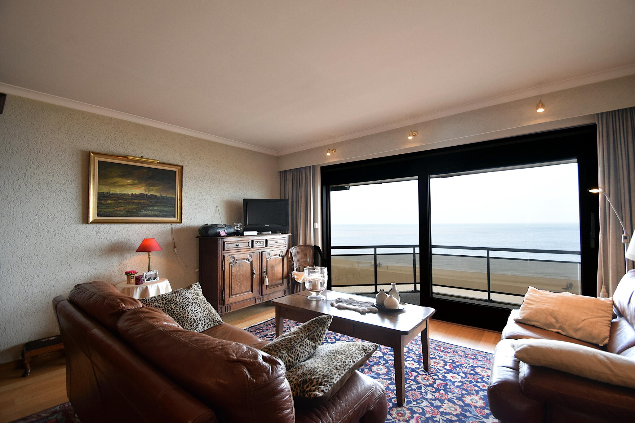 Charming Seaside Elegance
Step into timeless charm at this beautifully furnished apartment located in a refined residence along De Haanâ€™s serene Zeedijk. With its antique yet tasteful interior, cozy parquet flooring, and all the modern comforts, it offers a warm and inviting space for couples or families. Relax on the private terrace with stunning sea views, sip your morning coffee, or unwind with a glass of wine at sunset. With two comfortable bedroomsâ€”each with access to a bath or showerâ€”and an additional sleeping mattress, the apartment accommodates up to five guests.

A Belle Ã‰poque Coastal Gem
Located just 50 meters from the beach and a short stroll to the heart of De Haan, this stay blends history with coastal beauty. The areaâ€™s famous Concessiewijk quarter takes you back to the Belle Ã‰poque era with its romantic villas, no high-rise buildings, and relaxed, family-friendly vibe. Discover charming lanes, peaceful gardens, and local shops as you soak up the townâ€™s nostalgic, seaside atmosphere. Whether youâ€™re here for a quiet escape or a beachside adventure, De Haan makes every moment memorable.

Local Tastes and Tranquility
After a day at the beach or a round at The Royal Golf Club Ostend, explore nearby restaurants offering fresh seafood and Belgian specialties. Try dining at beachside brasseries or cozy local cafÃ©s just 500 meters away. Return home to unwind in your peaceful retreat, free from pets and smokeâ€”designed for pure comfort and serenity.