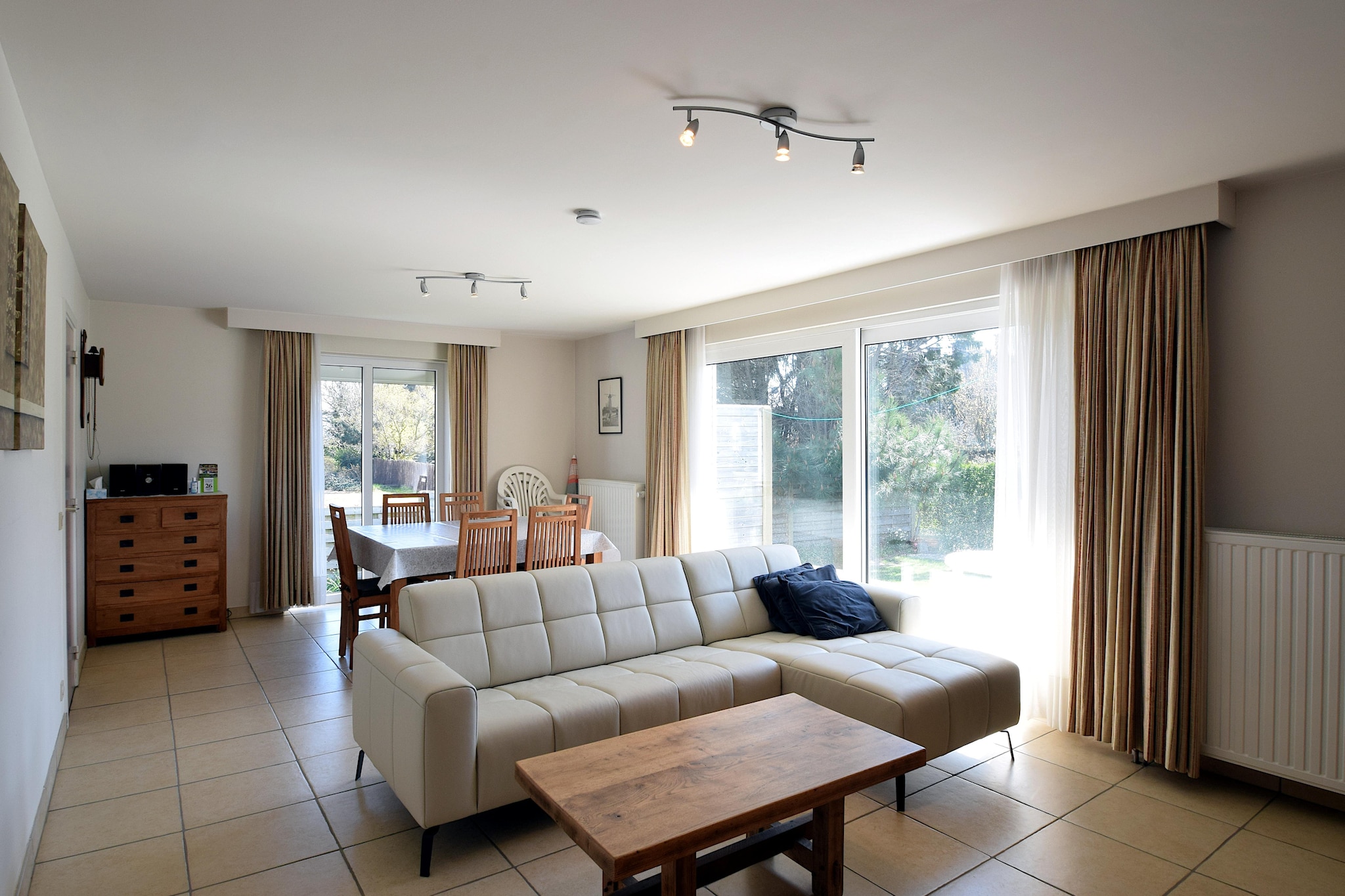 Coastal Comfort with a Private Garden
Step into this sun-kissed ground-floor apartment, perfectly situated just 50 meters from the beach. With a bright and inviting interior, this cozy retreat is designed for ultimate comfort and relaxation. The south-facing terrace opens into a fully enclosed private gardenâ€”ideal for enjoying sunny afternoons with a book or sharing meals under the sky. Two well-appointed bedrooms, one with an ensuite shower, plus a second bathroom and separate toilet, offer both convenience and privacy for up to five guests.

Prime Location in De Haan
Located on Koningklijke Baan in the heart of De Haan, this charming stay places you steps from the sea and a short stroll from the resort town's iconic Belle Ã‰poque charm. Walk along the scenic coastal promenade, explore nearby parks, or hop on a bike for a ride through the dunes. A private garage box ensures secure parking, and everything from bakeries to beach bars is within easy reach.

Dining & Local Delights
Savor fresh seafood at local favorites like Mano or Le Kok sur Mer, both just minutes away. From elegant bistros to beachside cafÃ©s, De Haan offers culinary options to suit every palate. After a delicious meal, return to your quiet retreat, curl up in the cozy living area, and stream your favorite show with digital TV. Please note: pets are not permitted, ensuring a pristine stay for every guest.