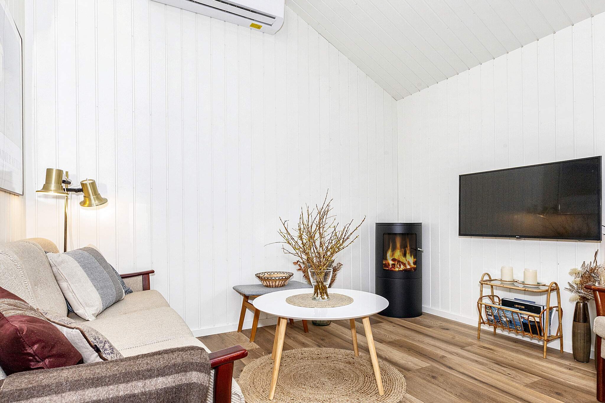 This very cozy and well-maintained vacation home, built in 2021, is located in Lendrup Stand, very close to the mussel town of LÃ¸gstÃ¸r and on the Limfjord in picturesque surroundings.

The well-appointed holiday home has a kitchen-living room with access to the terrace, two double bedrooms with high-quality beds, a bathroom with washing machine and rain shower, and a loft with two sleeping places. The living area is open to the rafters, which gives the room a fantastic volume. The kitchen is very well equipped with a dishwasher, induction hob, oven, microwave, and fridge/freezer. The living room has a heat pump and a biofireplace, and there is underfloor heating in the kitchen and bathroom. There is a flat-screen TV with the option of streaming via Chromecast for your own TV providers.

The cozy garden has garden furniture, a gas grill, and an outdoor shower with cold and hot water, as well as a robotic lawn mower. The garden is fenced in, so you can enjoy privacy and sit comfortably even on windy days.

Opposite the house, a path leads directly down to the nearby fjord shore (150 m). The beach there is very child-friendly and beautiful sunsets are guaranteed.

There is a charging plug for electric cars with a maximum of 10 amps.

No rentals to youth or trades groups, please!