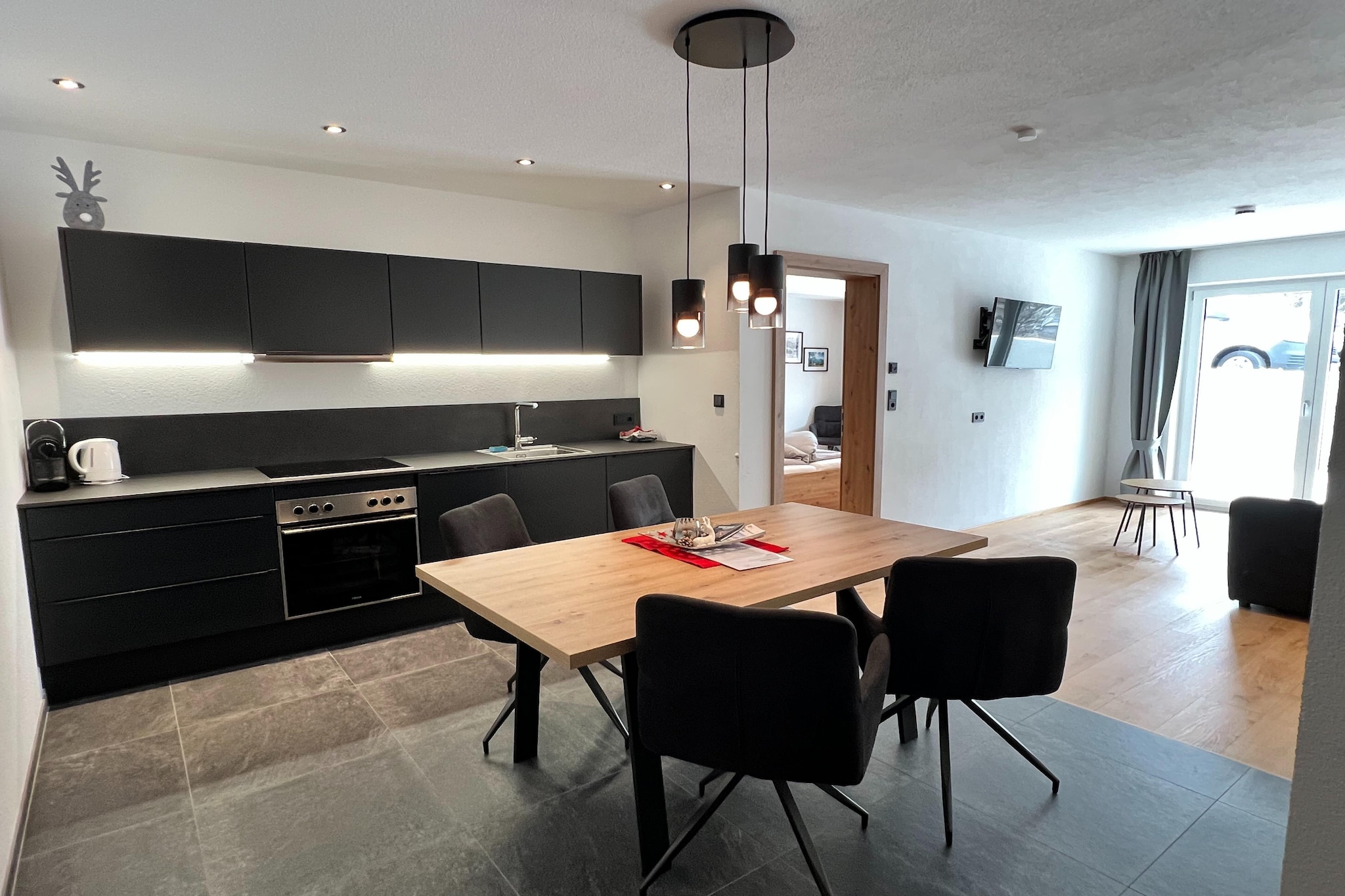 Ground floor: (open kitchen(hob(4 ring stoves, induction), electric kettle, toaster, coffee machine(cups), oven, dishwasher, fridge(+ freezer), fridge-freezer), Living/diningroom(single sofa bed, TV, dining table), bedroom(double bed), bedroom(double bed), bathroom(shower, washbasin, toilet), bathroom(shower, washbasin, toilet), terrace(35 m2), garden furniture)\n\nski storage, garage, stove, coffee machine, dishwasher, ski boot heaters, bicycle storage, parking