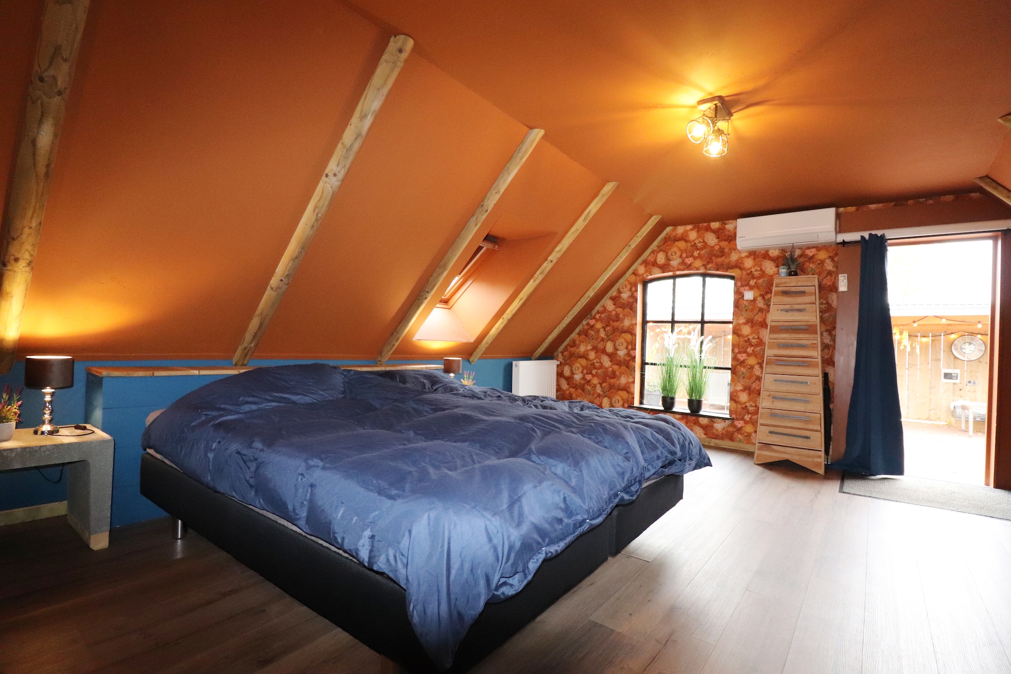 The holiday home is located in the picturesque village of Haulerwijk, surrounded by lush woods and tranquil waterways. It is the perfect destination for couples seeking a peaceful retreat away from the hustle and bustle of city life. With its stunning views of the canal and surrounding nature, this former flour factory has been transformed into a comfortable and modern apartment that offers all the amenities you need for a relaxing stay. 

The holiday home's location is ideal for those who enjoy outdoor activities. Start the day with a refreshing morning walk in the neighbouring forest. With beautiful cycle paths and walking routes winding through the surrounding wooded area, guests can explore the natural beauty of Haulerwijk at their own pace. There is also a canal right in front of the holiday home, providing a peaceful and serene spot for fishing. The nearby restaurants offer regional and international cuisines within walking distance of the property. The wellness centre is 6 km away for refreshing the mind, body, and soul. 

The apartment itself is spacious and well-appointed, featuring a large living room with an open kitchen, a very spacious bedroom with its own bathroom, and a large sunny roof terrace with a dining area, lounge set, and a heater for a warm and cozy atmosphere. Notably, a closet/bed has been added in the living room, which can be folded out into a double bed.
The terrace also has a spacious roof for shade and shelter, offering a perfect place to relax and take in the stunning views. For guests who own electric bicycles, the holiday home features a dry place to store and charge them. This added convenience makes it easy for guests to explore the surrounding area and all it has to offer. Whether you're looking for a quiet and peaceful getaway or a base for exploring the sights and attractions of Haulerwijk and the surrounding area, this holiday home is a perfect choice. 

Storage of motorcycles is possible in the large shed, please notify the house owner in advance.

Breakfast is possible