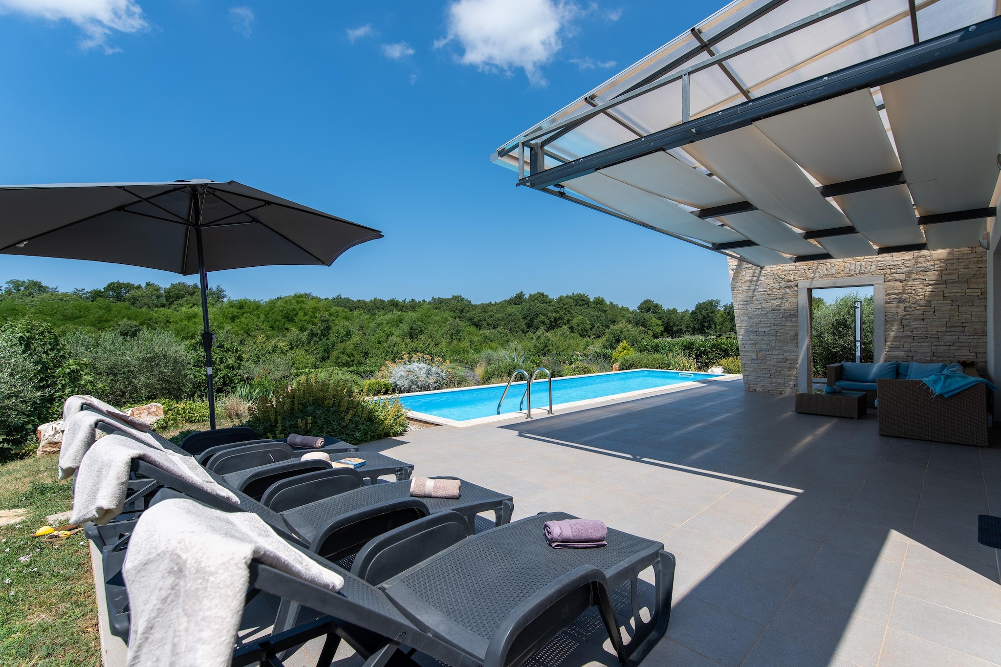 Modern villa with pool, covered terrace and sea view