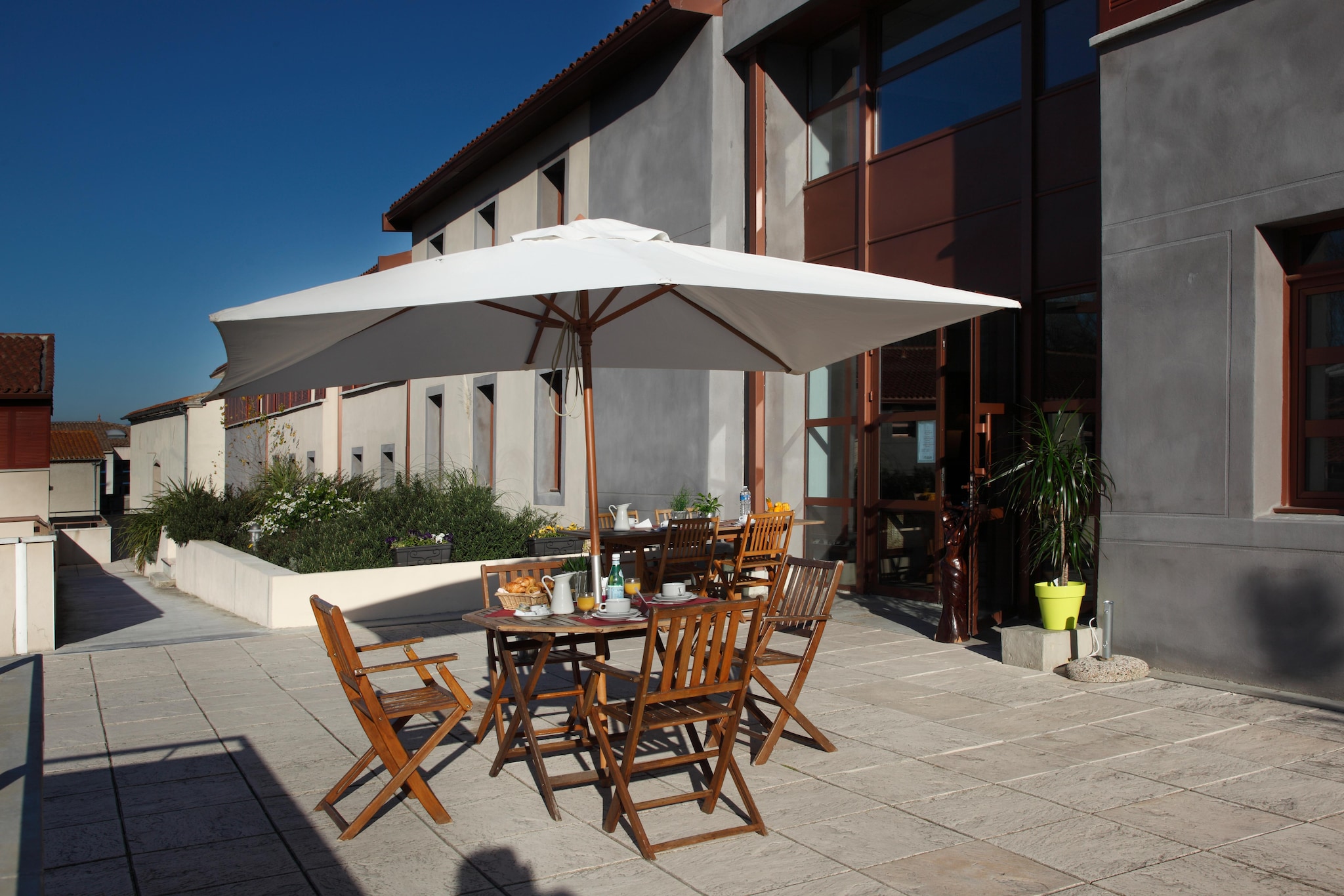 At the base of Carcassonneâ€™s legendary medieval fortress, this charming holiday residence offers the perfect gateway to history, culture, and relaxation. With its prime location just steps from the UNESCO-listed CitÃ©, you can start your mornings with the sight of centuries-old towers and cobbled lanes waiting to be explored. Whether youâ€™re here to immerse yourself in the cityâ€™s rich heritage or simply unwind, the atmosphere blends old-world magic with modern-day comfort.

The residence features elegantly designed, air-conditioned apartments, each thoughtfully crafted to provide a peaceful retreat after days filled with discovery. Begin your morning in the inviting breakfast room, share quiet moments on the pretty communal terrace, or enjoy the convenience of on-site parking. Every detail is designed to make your stay both comfortable and memorable, while placing you right at the heart of Carcassonneâ€™s allure.

From your doorstep, wander to the majestic Basilica of St. Nazaire, cross the storied Pont Vieux over the River Aude, or lose yourself in the labyrinth of medieval streets. And with the fortress just 300 meters away, youâ€™re never far from its imposing walls, vibrant markets, and atmospheric cafÃ©s. Here, each day offers the perfect mix of historyâ€™s enchantment and the ease of a modern escape.
