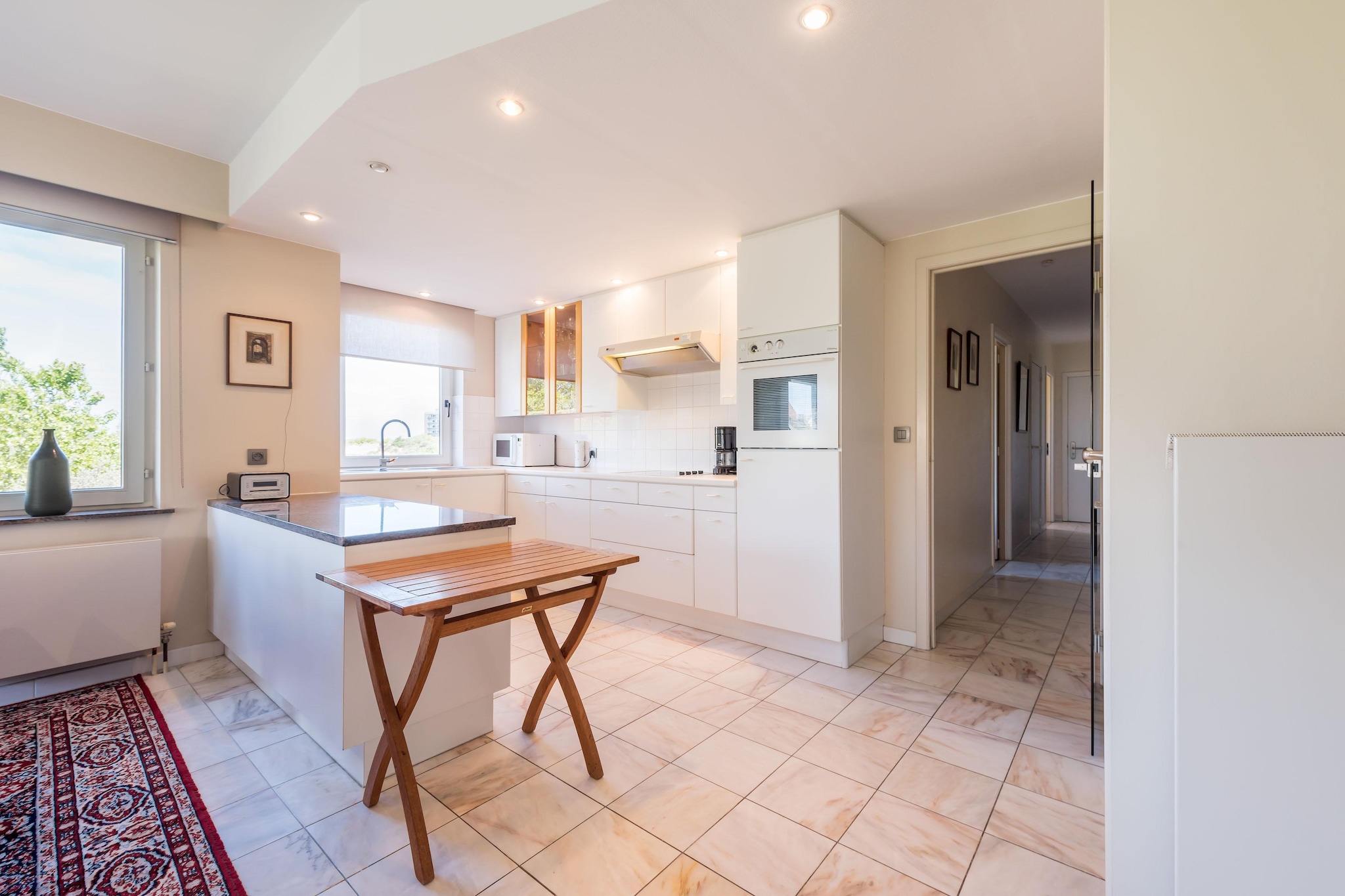 On the 1st floor: (Kitchen(hob(ceramic), hood, coffee machine, oven, microwave, dishwasher, fridge(+ freezer)), Living/diningroom(TV(flatscreen, digital), dining table(6 persons), seating area), bedroom(single bed, bunk bed), bedroom(double bed(boxspring)), bathroom(bath tub, shower, washbasin), toilet(toilet))\n\ngarage, tumble dryer, washing machine, balcony, heating(central, gas), garden furniture, lift, ironing board, iron