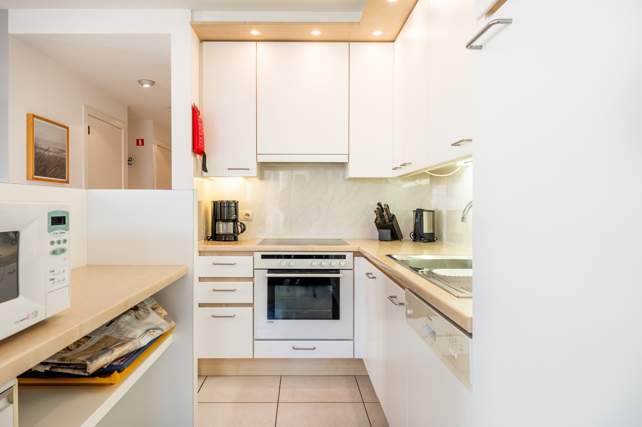 On the 1st floor: (open kitchen(hob(ceramic), electric kettle, toaster, hood, coffee machine, oven, combination microwave, dishwasher, fridge(+ freezer), Hand blender), Living/diningroom(double sofa bed, TV(flatscreen, digital), dining table, seating area, balcony), bedroom(double bed), bedroom(bunk bed), bathroom(bath tub, washbasin), toilet(toilet))\n\nwashing machine, heating(electric), garden furniture, parking, lift, ironing board, iron