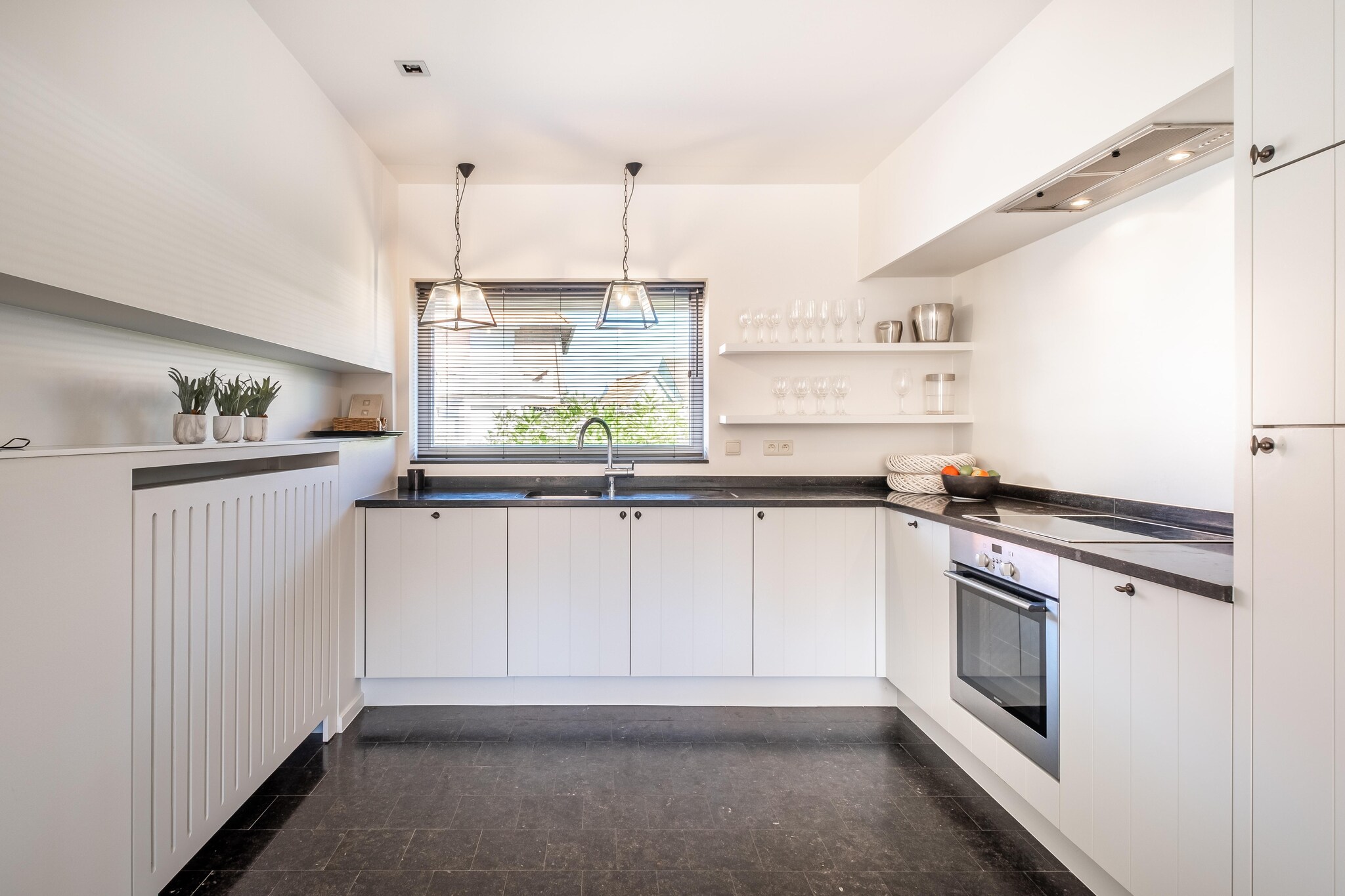 Ground floor: (Living room(TV, seating area), dining room(dining table), Kitchen(hob(ceramic), electric kettle, coffee machine, oven, microwave, dishwasher, fridge(+ freezer), freezer, Hand blender))\n\nOn the 1st floor: (bedroom(bunk bed), bedroom(double bed, TV), bedroom(double bed), bathroom(bath tub, washbasin), bathroom(Bubble bath, shower))\n\nAttic: (bedroom(single bed, single bed))\n\ngarage, heating, terrace(fenced, 10 m2), garden, garden furniture, BBQ, deckchairs, sand pit, high chair