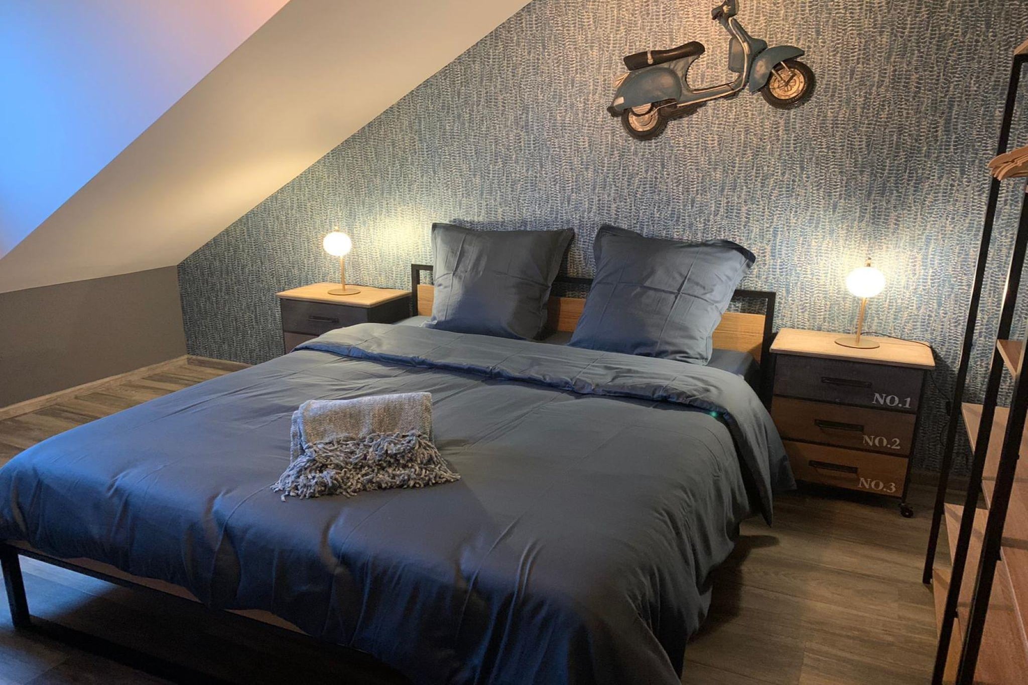 Ground floor: (hallway(toilet, changing mat), Sitting room(TV, fireplace, seating area), dining room(dining table), open kitchen(electric kettle, toaster, cooker, hood, coffee machine, espresso machine, oven, microwave, dishwasher, fridge, freezer, Blender), washing room(washing machine), relaxation area(seating area, table football, darts, party games), terrace)\n\nOn the 1st floor: (bedroom(single bed, single bed, single bed, single trundle bed), bedroom(double bed, TV), bedroom(double bed, TV), Bedroom with bathroom(double bed, TV, shower, washbasin, toilet), bathroom(bath tub, shower, washbasin, washbasin, toilet), toilet(washbasin))\n\nrecreation room, carport, bunk bed, stove, cot, bathtub or shower, heating, terrace, garden, bicycle storage, garden furniture, sun loungers, BBQ, parking, deckchairs, parasol, children\'s bed, high chair, ironing board