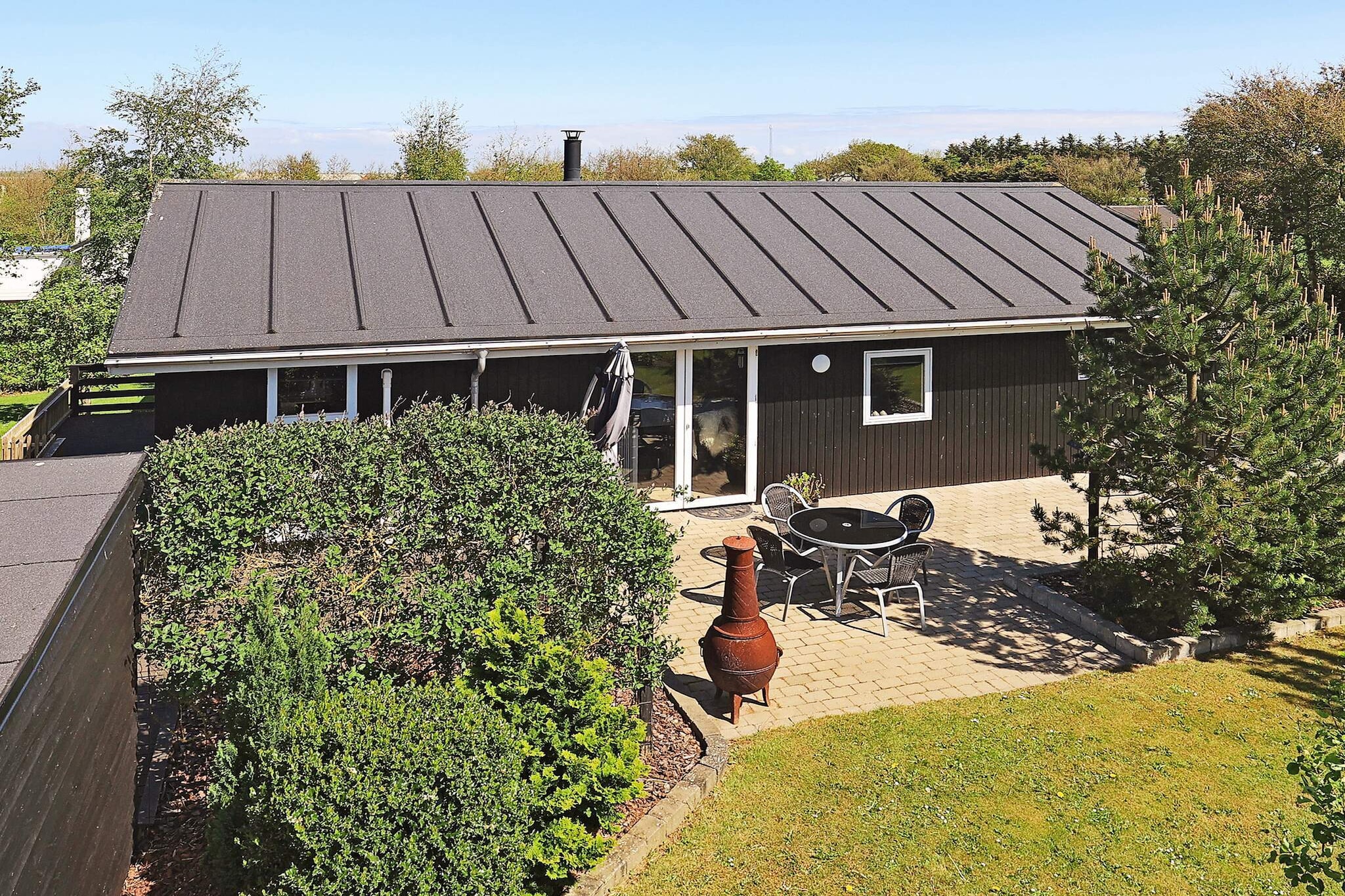 Well-located and well-maintained vacation home with a view of the water, located only about 200 meters from the Limfjord with a child-friendly beach at Livbjerggård. The cottage's garden offers ample opportunity to enjoy your vacation in peace and quiet, as well as the opportunity for ball games and play. In addition, there are several cozy nooks that are perfect for reading a good book while the kids play in the garden. The house is energy efficient with a heat pump, which means lower consumption.The holiday home is bright and inviting and practically furnished with a combined living room/kitchen. The living room has modern furniture, free internet, and a flat-screen TV with German channels, international channels, and Danish TV, including TV2. Partially renovated in 2021 with a new kitchen including a ceramic stove, range hood, microwave, coffee maker, refrigerator/freezer, and dishwasher.Bathroom with shower, bathtub, toilet, washing machine, and dryer. There are two bedrooms with comfortable beds, one with a double bed and one with two single beds. The last sleeping space is on the sofa in the living room.The house has both an open and covered terrace with comfortable garden furniture and a gas grill, where you can enjoy dinner while watching the sun set over the area.The house also has a fire pit where the whole family can enjoy roasting sausages and marshmallows or baking bread on a stick.Not available for rental to youth groups or construction crews.A refundable deposit might be charged closer to your check-in date. The security deposit ensures a smooth stay and covers any additional services or consumption charges.This deposit covers utilities consumed during your stay and any additional services that may be taken.The final amount will be adjusted based on actual meter readings, actual usage of extra services, and any remaining balance will be refunded within 21 days after checkout.This deposit simply acts as a prepayment for charges that  you would anyways pay for, ensuring a seamless stay and check-out experience.