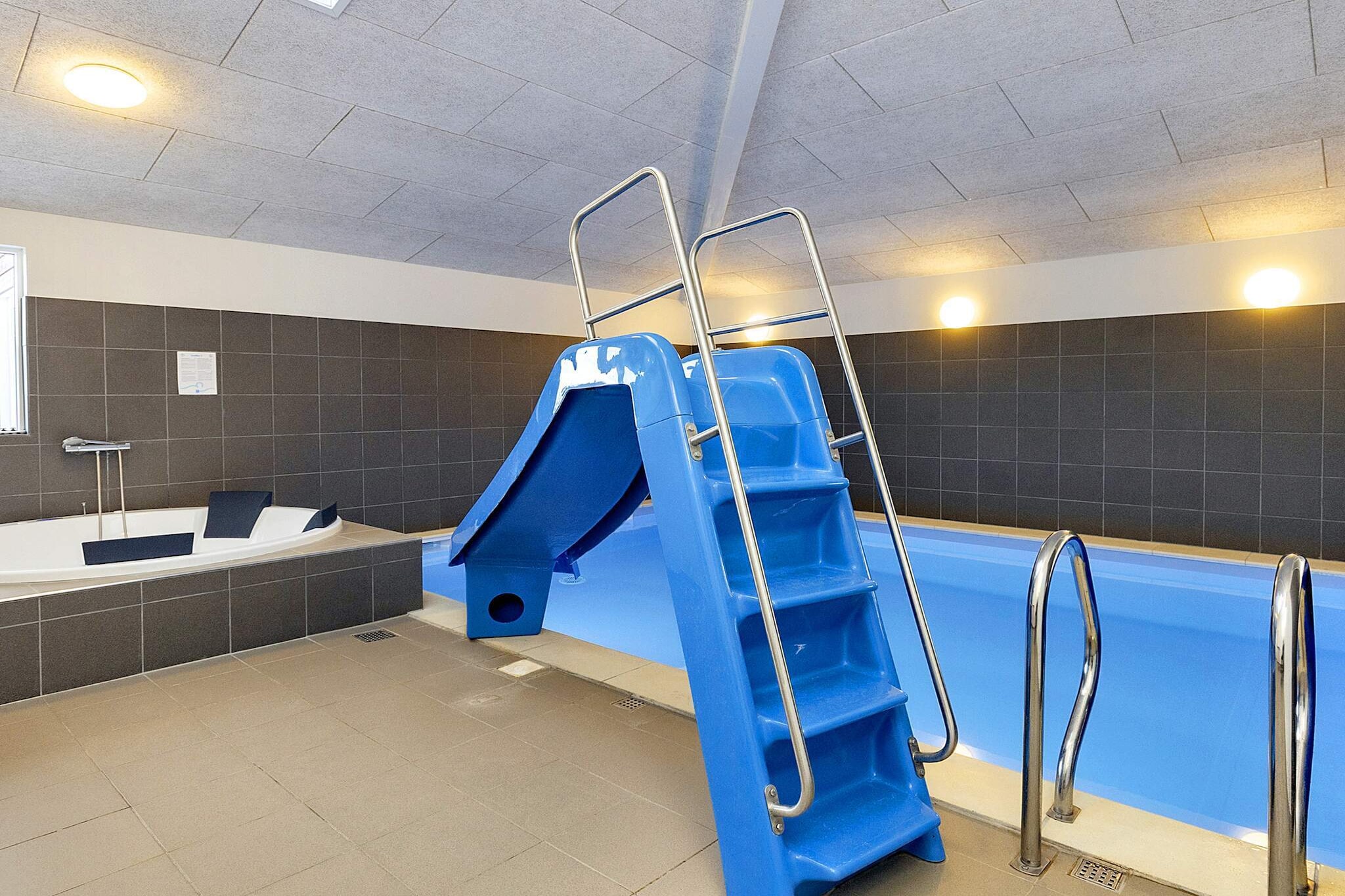 Kitchen(cooker(electric), coffee machine, microwave, dishwasher, fridge, freezer(140-199L), high chair), Living/bed room(TV, DVD player), bedroom(double bed, children\'s bed), bedroom(double bed), bedroom(double bed), bedroom(double bed), bedroom(2x single bed), bedroom(2x single bed), bedroom(2x single bed), bathroom(tumble dryer, washbasin, shower, toilet, washing machine), bathroom(washbasin, shower, toilet), bathroom(washbasin, shower, toilet), mezzanine(2x single bed), mezzanine(2x single bed), TV, stereo unit, Bubble bath(indoor, heated, 5 persons), sauna(indoor, 5 persons), heating(electric), terrace, garden furniture, sun loungers, swimming pool(indoor), play equipment, table tennis table, table football, football goal, billiards, geothermal energy