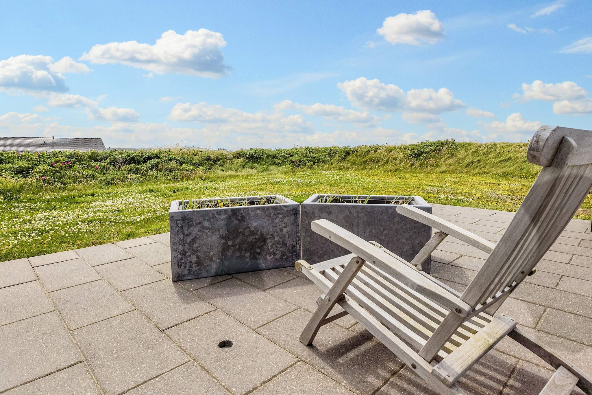 Fantastic exclusive holiday home with whirlpool located in the absolute first row to the sea at Lønstrup. From the house you have a formidable panoramic sea view - also called "a blue wall". Here you are about 40 meters above sea level and therefore have full pleasure in all the nuances that the sea creates throughout the day. In addition to the panoramic view of the sea and the coastal area, you also have a unique and direct view of, among other things, the world-famous Rubjerg Knude Lighthouse. The cottage is located on a 1260 m2 large open plot at the end of a cul-de-sac, which helps to make the experience even more unique. The cottage appears with a bright and tasteful décor. On the 1st floor there is, among other things, an extra living room, from which there is a beautiful view of the water. There are also 2 beds in a double bed at the end of the living room. One bedroom is arranged in a large and spacious loft, which is separated from the rest of the house by a glass wall with a glass door. This preserves the beautiful view from the room. A house that a lot of guests return to year after year. One living room and living room are in open connection with the kitchen. This provides ample opportunity for a joint holiday. If you need peace, there is also an extra living room on the 1st floor. In the house there is also a TV with Chromecast. The holiday home is equipped with two energy-saving heat pumps, a washing machine, a tumble dryer and a freezing capacity of 50 litres. The house's beautiful bathroom contains a lovely whirlpool. The bathroom has underfloor heating. The large plot, which is located directly on the beach, includes 70 m² of open terrace area. Of which a total of 35 m² is enclosed terrace. Here is a good opportunity for the whole family to gather around the garden grill. A tool room and garage are available. The house is not rented out to youth groups.A refundable deposit might be charged closer to your check-in date. The security deposit ensures a smooth stay and covers any additional services or consumption charges.This deposit covers utilities consumed during your stay and any additional services that may be taken.The final amount will be adjusted based on actual meter readings, actual usage of extra services, and any remaining balance will be refunded within 21 days after checkout.This deposit simply acts as a prepayment for charges that  you would anyways pay for, ensuring a seamless stay and check-out experience.