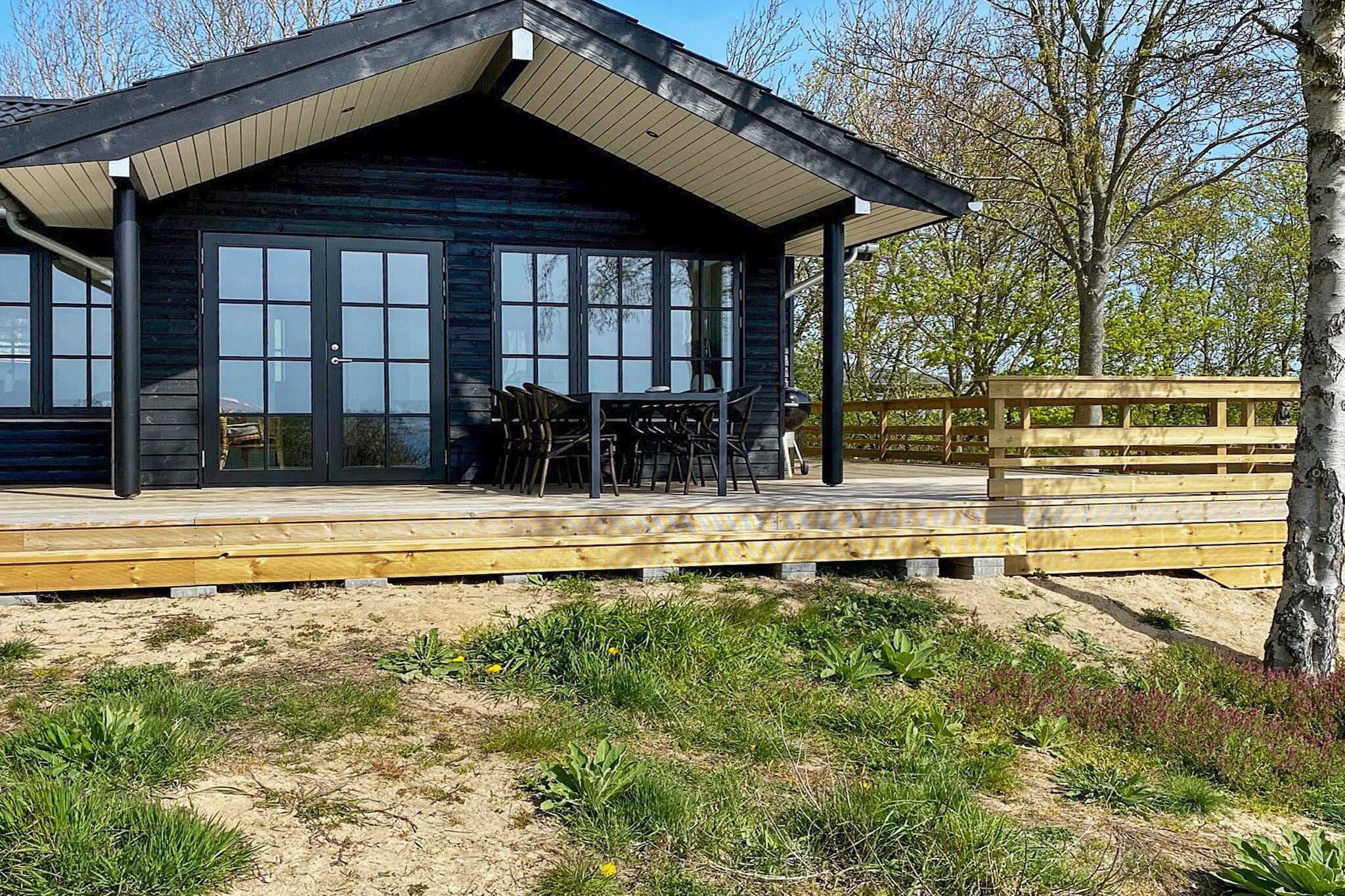 This charming holiday home is located on Fyns Hoved, the northernmost point of Funen, offering breathtaking views of the surrounding waters. Built in a cozy, typical Nordic style, it perfectly combines traditional charm with modern comfort, creating an ideal retreat for families, couples, or small groups seeking peace and relaxation.
Inside, the house features a bright, open-plan living and dining area with direct access to the terrace. Large panoramic windows fill the space with natural light and provide incredible, unobstructed sea views, allowing you to enjoy the scenery from almost every angle. The living area includes a TV and high-speed internet for entertainment, while maintaining a welcoming, homely atmosphere.
The kitchen is well-equipped with modern appliances, including a convection oven, extractor hood, and refrigerator. From the kitchen, you can step directly onto the terrace and property grounds, making it easy to enjoy outdoor meals or simply relax while taking in the coastal scenery.
Outside, the terrace offers the perfect space for morning coffee, evening drinks, or watching the sunset over the water. The property is surrounded by nature, providing peace, privacy, and easy access to scenic coastal walks. The unique location on the peninsula ensures tranquility while still being within reach of local attractions and hiking paths.
This holiday home combines Nordic charm, modern amenities, and stunning sea views, offering a memorable escape on Funen’s northern tip.
No rentals to youth groups are allowed.