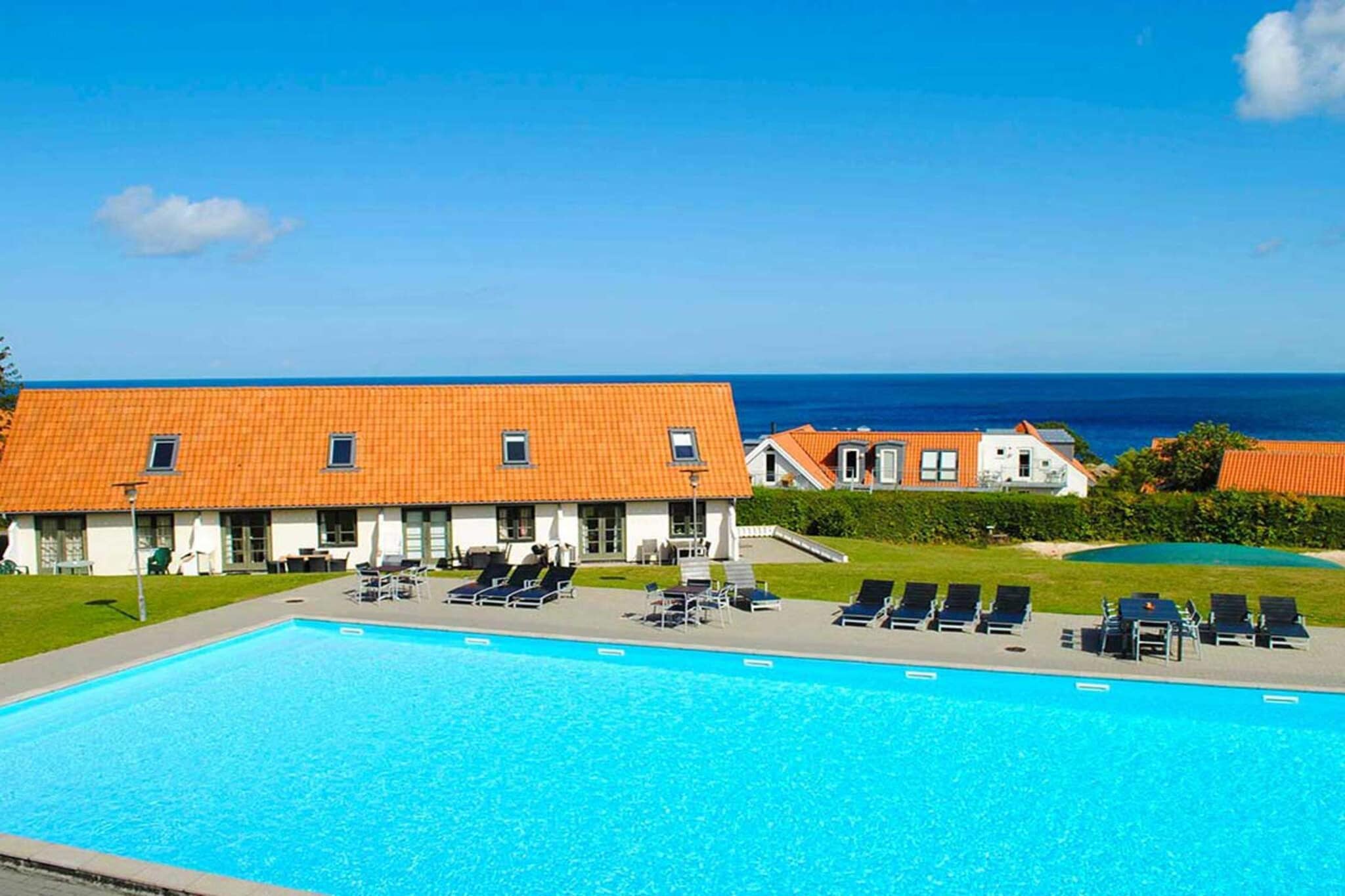 Gudhjem Holiday Park & # 8212; holiday on the sunny island Holiday homes in Bornholm style 10 min from the harbor and 5 min from the beach. The family's starting point for trips to Helligdomsklipperne, Paradisbakkerne, Christiansø m.v. Watch movies on YouTube. About Gudhjem Holiday Park In Gudhjem Holiday Park you can enjoy the sun over Gudhjem in the first floor. Here you and your family live in charming holiday homes beautifully situated on a slope & # 8211; some with views of the Baltic Sea. From here you have only a few minutes walk to the beach, and the harbor is only a 10 minute pleasant walk away. In the summer months you can swim and sunbathe by the large outdoor pool. ALL guests also have free access to Gudhjem Swimming Hall during their public opening hours. In addition, the holiday park has a playground with a bouncy castle to the great delight of the children. It is also possible to rent a bike from us or charge your electric car at our charging station. Idyllic Gudhjem Gudhjem is incredibly charming with its steep and winding streets, well-kept half-timbered houses and the many smoke chimneys. The area in and around Gudhjem is ideal for short or longer walks along the many paths in the forest as well as along the beautiful coastline. In Gudhjem there is a good selection of restaurants, cafes and ice houses. In addition, you will find mini golf and the exciting Oluf Høst Museum. Sail to unique Christiansø from Gudhjem From Gudhjem Harbor there is a daily departure to the completely unique and historic rocky island Christiansø, where everything from buildings to wildlife is protected. The sailing trip to Christiansø takes approx. 55 min. Holiday home on Bornholm If you can not find a vacant holiday home in your desired period, you can search for holiday home on Bornholm.