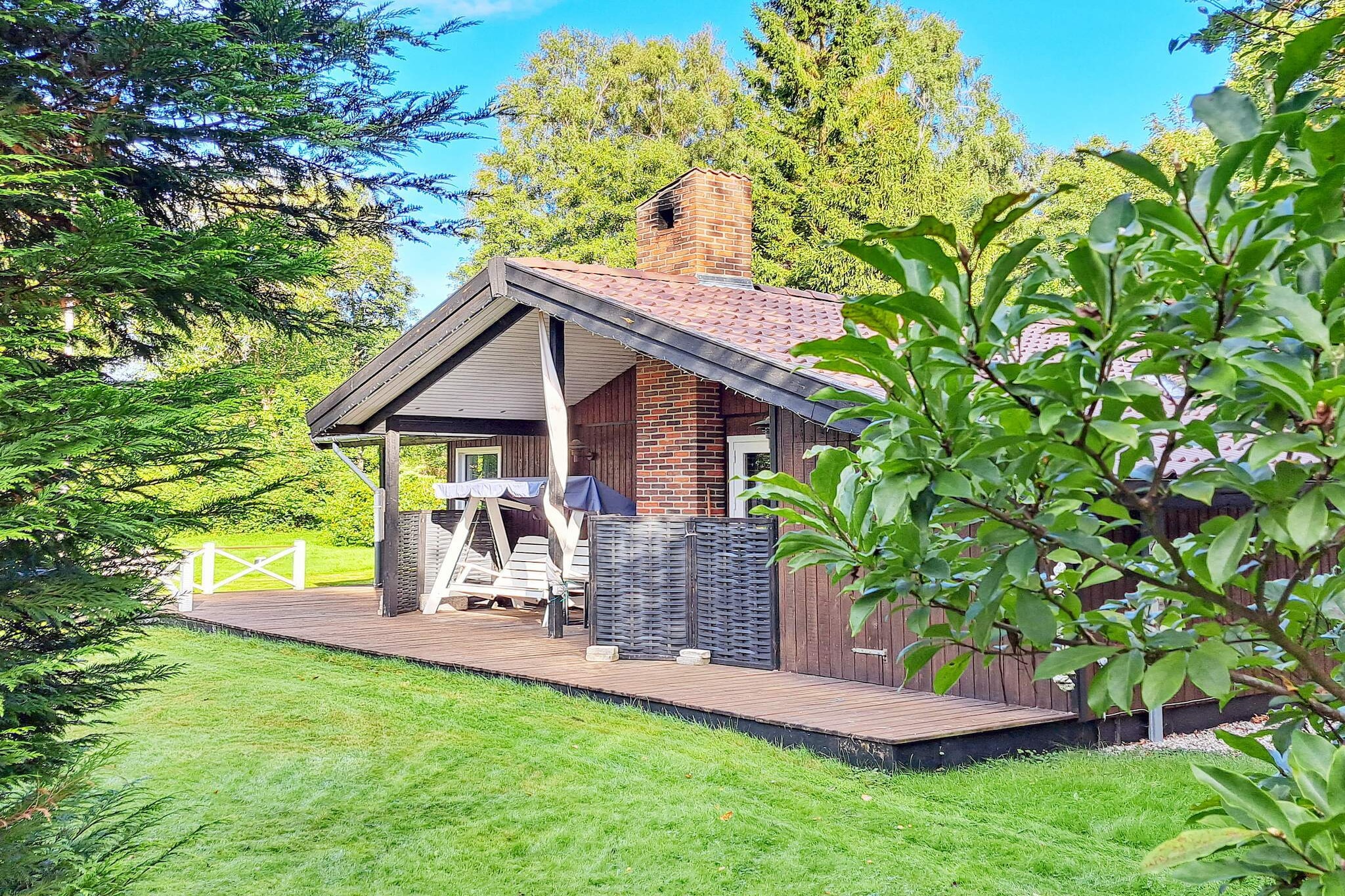 Kitchen(cooker(2 ring stoves), coffee machine, oven, microwave, dishwasher, fridge-freezer), Living/bed room(TV(danish TV channels (DR1 and TV2)), stereo unit, chromecast), bedroom(2x single bed), bedroom(2x single bed), bedroom(single folding bed, bunk bed), bathroom(floor heating)(washbasin, shower, toilet, washing machine), carport, balcony or terrace, heating(electric), terrace, garden, garden furniture, play equipment, air to air heatpump