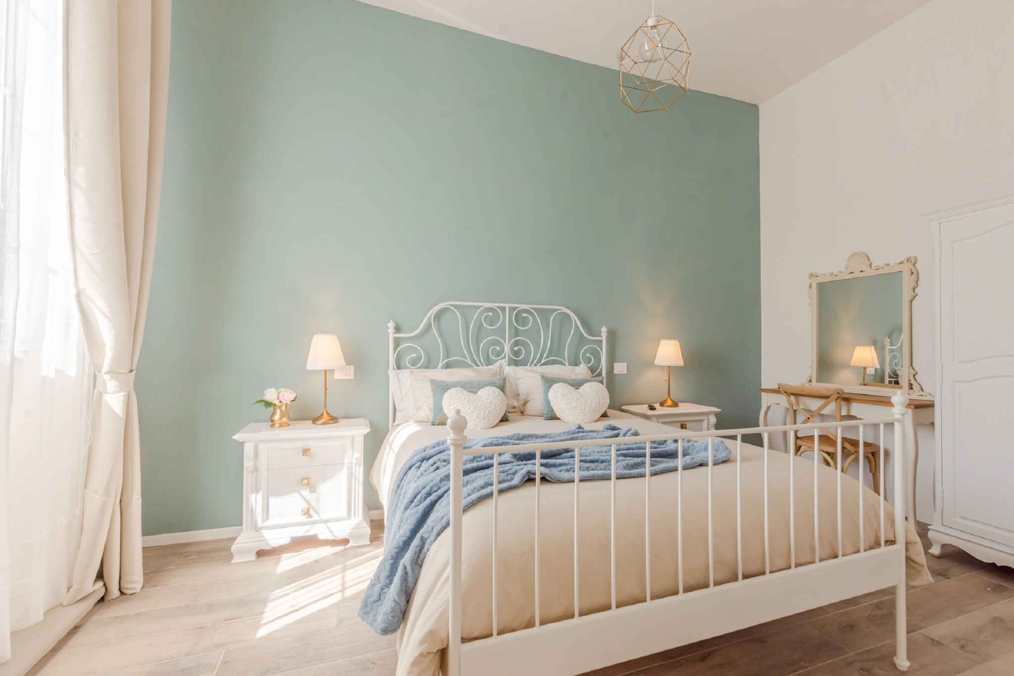 Ground floor: (Living room(double sofa bed, TV, dining table, seating area), open kitchen(hob, espresso machine, oven, microwave, fridge, washbasin), bedroom(double bed, TV), Bedroom with bathroom(small double bed, TV, shower, washbasin, toilet), bathroom(shower, washbasin, toilet))\n\nparking