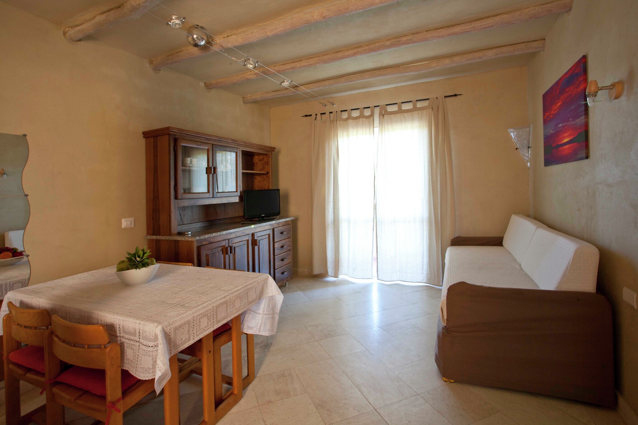 Located in the serene surroundings of Olbia, this pet-friendly holiday home offers a cozy retreat for 2 guests, making it ideal for couples or solo travelers. Just 1.3 km from the sandy shores of Spiaggia dei Bambini, youâ€™ll enjoy easy access to sun-soaked beaches and vibrant seaside life.

Spend your days exploring Marinella (1.2 km), dining in nearby restaurants (1.8 km), or unwinding by the sea. For more adventure, head to Porto Rotondo (5.8 km) or the luxury of Porto Cervo (25.8 km). The airport is conveniently just 15 km away, and the ferry port is only 5 km from home.

Inside, youâ€™ll find a comfortable bedroom, a well-equipped open kitchen, and a bright living area with a TV. Air conditioning ensures a pleasant stay throughout the year. For a fun afternoon, enjoy a game on the paid tennis court, or use the paid washing machine for extended stays. With on-site parking, optional cot and high chair rental, and one pet allowed for â‚¬30/stay, this Olbia escape is the perfect mix of comfort, convenience, and relaxation.