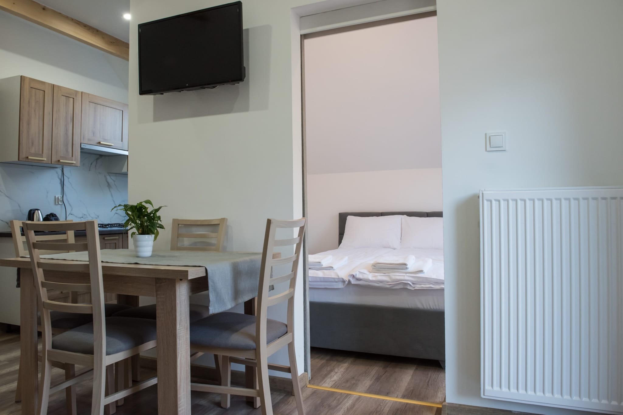 Family holiday resort with swimming pool, in a quiet area, next to a large water park. 10 minutes walk to the seaside beach.
Comfortable, 2-room holiday apartment on the first floor. It is adapted for comfortable relaxation of 4 people. It consists of a living room (double, fold-out sofa, table with chairs and TV), a bedroom with a double bed and a bathroom with shower. The living room is connected to the kitchen. The apartment has a terrace, where a set of garden furniture and a barbecue await. Guests have access to wireless internet.
The biggest attraction of the resort is the new swimming pool with heated water (open from May to September). The pool has a roof. On the fenced area of ​​the holiday complex there is a parking lot (1 space/house), volleyball court, playground and bicycle rental.
The price of the stay includes: bed linen, towels, water consumption, electricity consumption, heating, swimming pool, internet, final cleaning, parking (1 space/apartment), baby cot and highchair (reservation required).
Jarosławiec is a quiet summer resort located on the central coast, close to Darłowo and Ustka. Wonderful climate and landscapes, pine forests, clean water in the sea, seaside cliff - these are the advantages of Jarosławiec, which make this town attract crowds of tourists every year. Many interesting attractions await holidaymakers who spend their holidays here, which will diversify their seaside vacation. Jarosławiec also offers a rich gastronomic base. The beach in Jarosławiec is ideal for tourists who like to sunbathe in uncrowded places. On the beach you can see colorful fishing boats and find golden amber. After the last renovation, the beach is very wide and beautiful.
You can go to the nearby lake (approx. 2 km), where you can also swim, or rent a fishing boat.