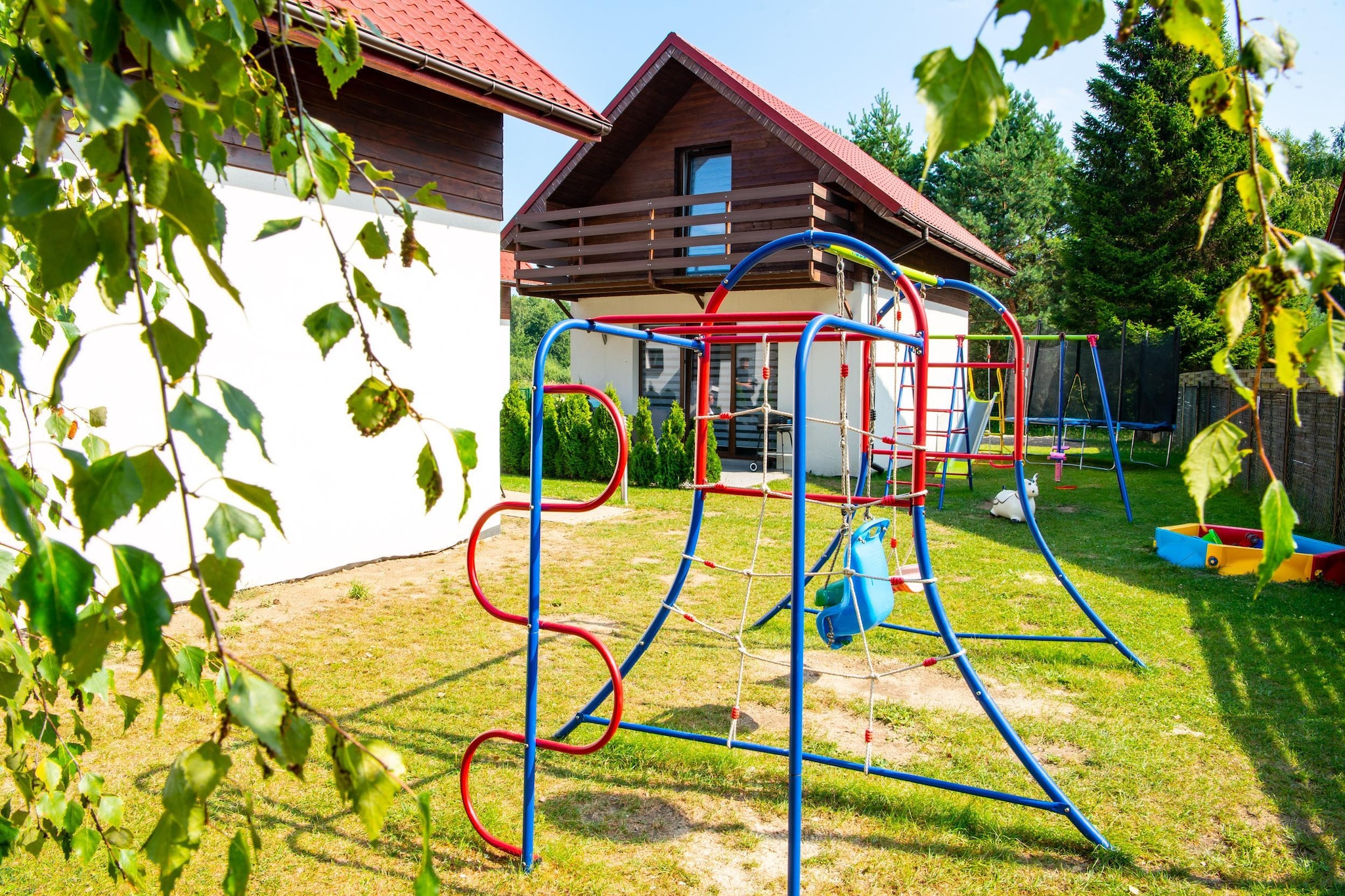 Family holiday resort with swimming pool, in a quiet area, next to a large water park. 10 minutes walk to the seaside beach.
Comfortable, 2-room holiday apartment on the ground floor. It is adapted for comfortable relaxation of 7 people. It consists of a living room (double, fold-out sofa, table with chairs and TV), 2 separate bedrooms and a bathroom with shower. The living room is connected to the kitchen. The apartment has a terrace, where a set of garden furniture and a barbecue await. Guests have access to wireless internet.
The biggest attraction of the resort is the new swimming pool with heated water (open from May to September). The pool has a roof. On the fenced area of ​​the holiday complex there is a parking lot (1 space/house), volleyball court, playground and bicycle rental.
The price of the stay includes: bed linen, towels, water consumption, electricity consumption, heating, swimming pool, internet, final cleaning, parking (1 space/apartment), baby cot and highchair (reservation required).
Jarosławiec is a quiet summer resort located on the central coast, close to Darłowo and Ustka. Wonderful climate and landscapes, pine forests, clean water in the sea, seaside cliff - these are the advantages of Jarosławiec, which make this town attract crowds of tourists every year. Many interesting attractions await holidaymakers who spend their holidays here, which will diversify their seaside vacation. Jarosławiec also offers a rich gastronomic base. The beach in Jarosławiec is ideal for tourists who like to sunbathe in uncrowded places. On the beach you can see colorful fishing boats and find golden amber. After the last renovation, the beach is very wide and beautiful.
You can go to the nearby lake (approx. 2 km), where you can also swim, or rent a fishing boat.