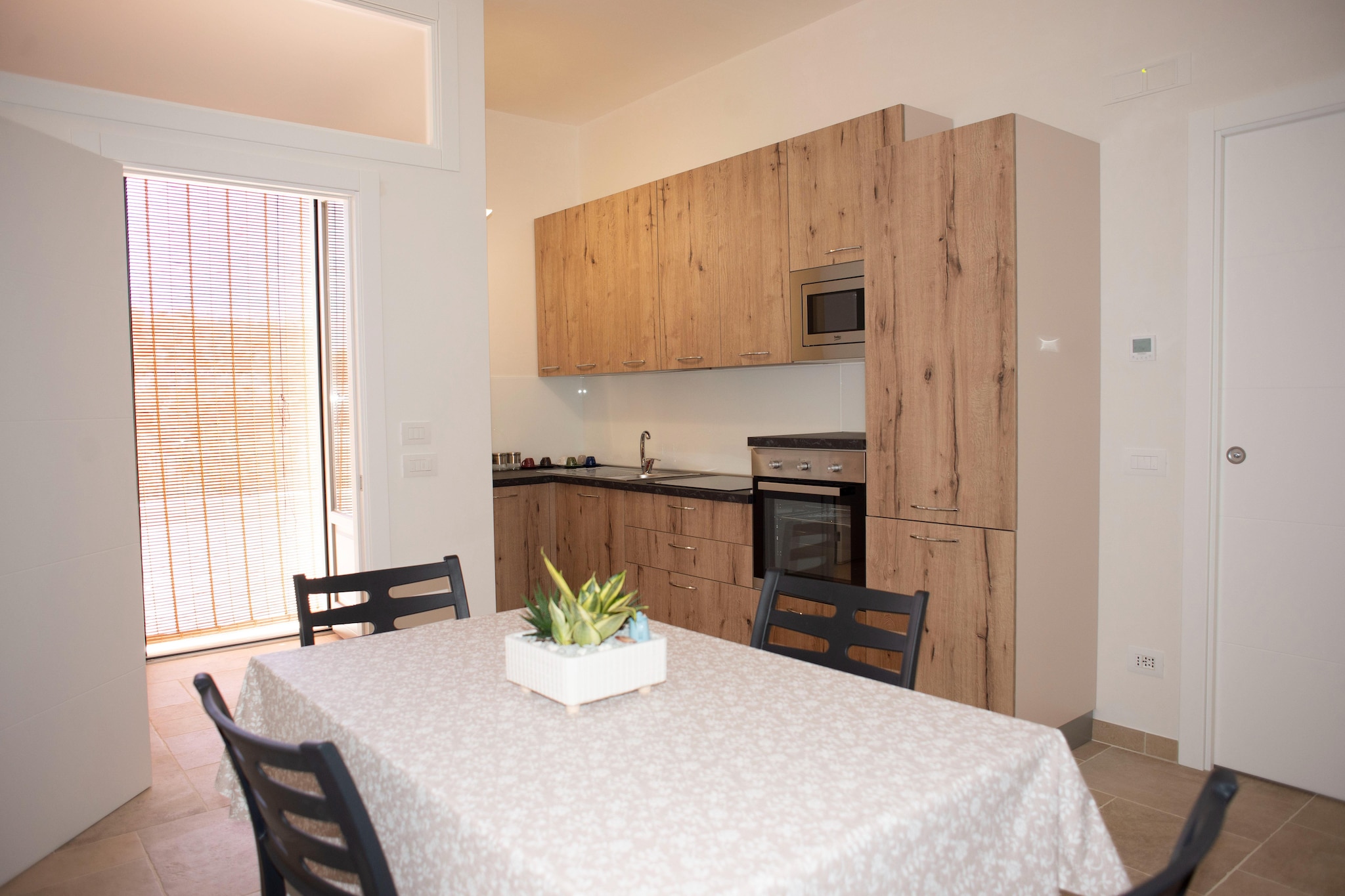 Ground floor: (Large kitchen(dining table, hob(electric), oven, microwave, fridge), bedroom(double bed), bedroom(single bed, single bed), bathroom(shower, toilet, bidet))\n\nParking, grill, washing machine, heating, air conditioning, terrace(private, roofed), garden(shared with other guests), garden furniture, iron