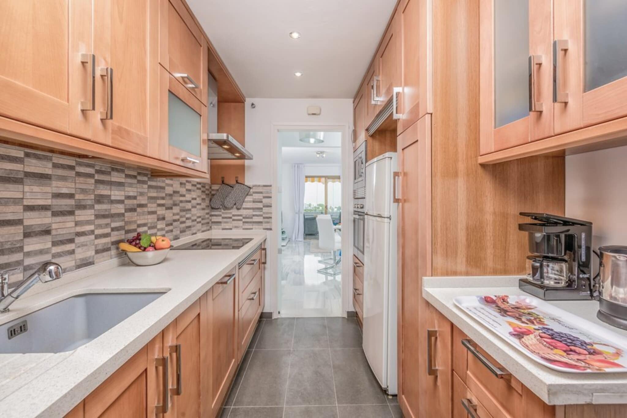 Living room(TV, dining table, seating area), open kitchen(hob(ceramic, induction), electric kettle, toaster, coffee machine, oven, microwave, fridge-freezer, washing machine), bedroom(double bed), bedroom(single bed, single bed), bathroom(shower, washbasin, toilet), garage(shared with other guests), balcony or terrace, air conditioning, garden furniture, swimming pool(shared with other guests), lift