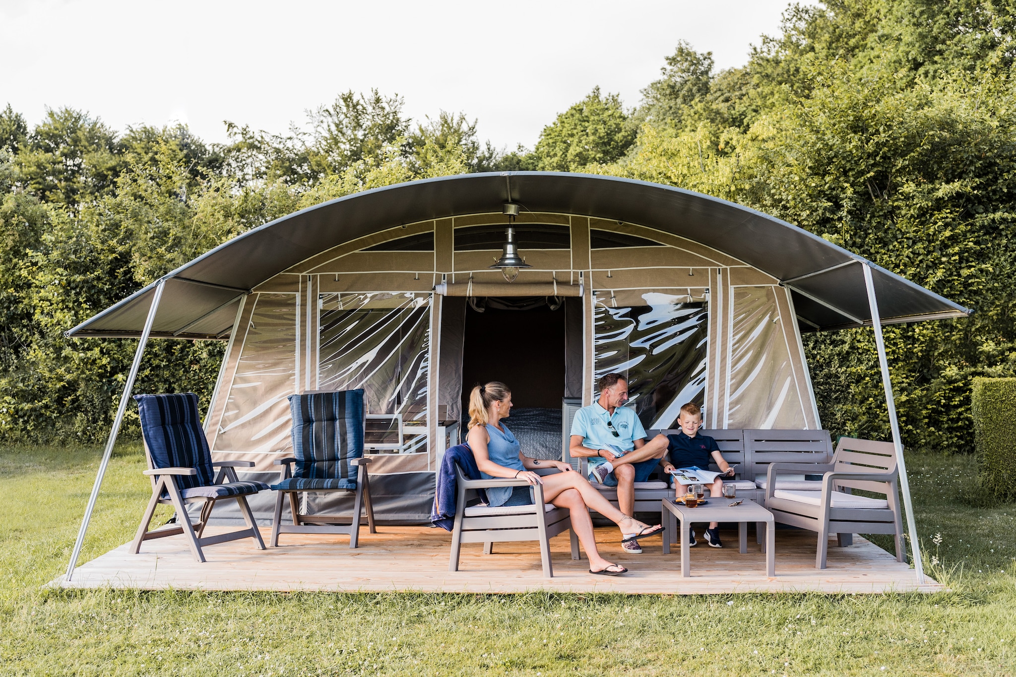 This nice, detached tent lodge is located on the modern terraced camping site Nommerlayen, adjacent to a beautiful forest. The holiday park is located in a green and water-rich hilly landscape near the small-scale town of Nommern, 30 km. north of the capital Luxembourg.

The tent lodge is furnished in a comfortable, nice and complete way. Here, you will experience the real camping feeling, but with just a little more comfort. There is a living area with an open kitchen, including a fridge, freezer and a hob. There are three bedrooms, one of which has a double box spring bed, one with two single beds, which may be set up as a double bed, and one with a single bed. The tent lodge does not have a private bathroom. For the shower and toilet you use the central sanitary facilities at the campsite. 

Outside you will find a lovely covered terrace with garden furniture. There is parking for one car near the tent lodge.

At holiday park Camping Nommerlayen you can book various safari tents and tent lodges for five people. Some types of tents have their own sanitary facilities.