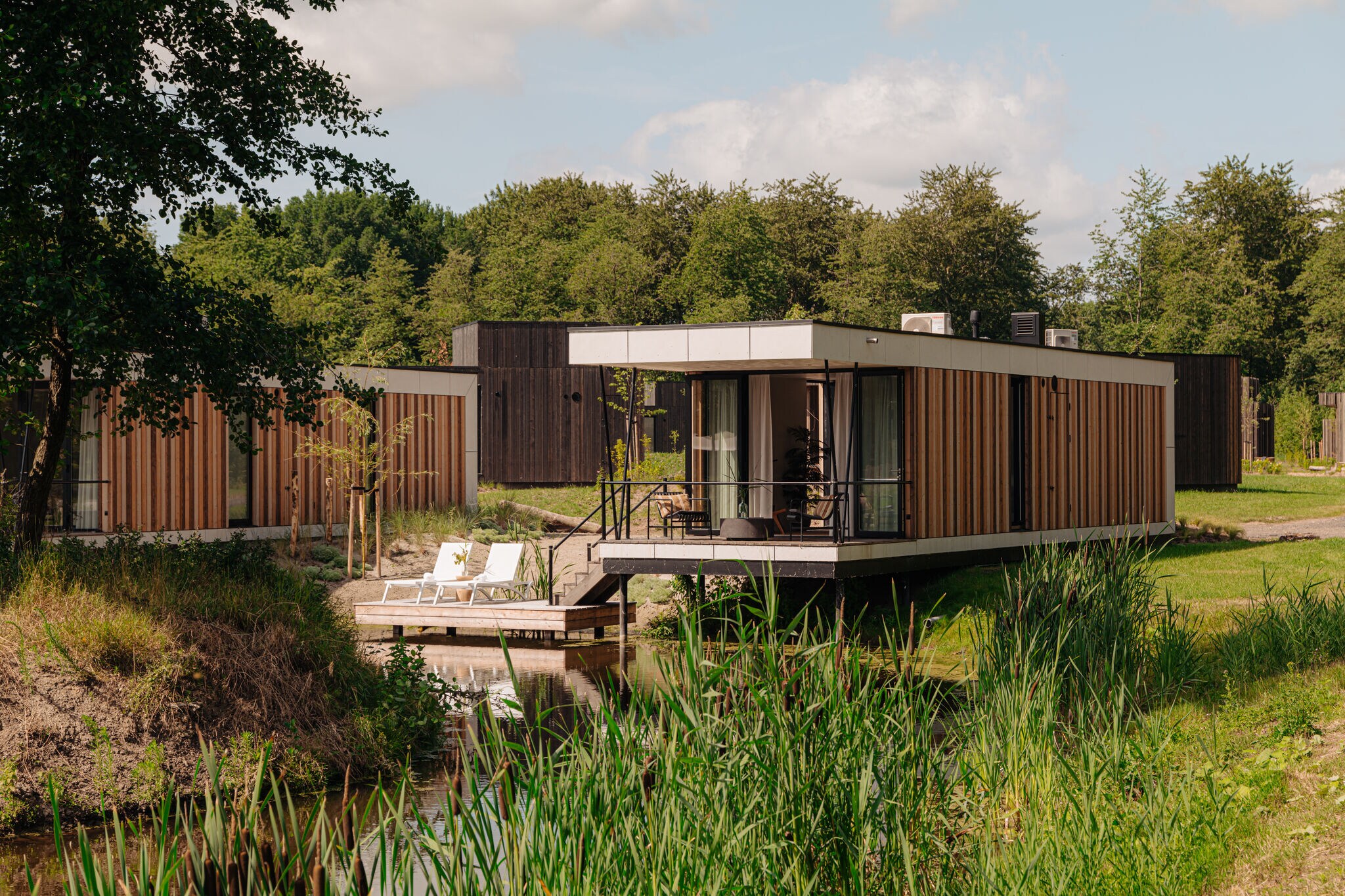 Modern lodge on the water in a holiday park