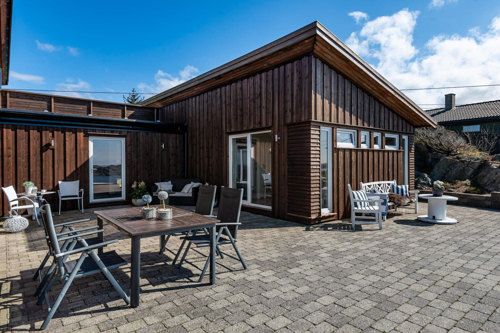 Beautiful, modern holiday home with a panoramic view of the sea, where you can enjoy the sunsets from a wilderness bath. Bright and pleasant holiday home in quiet surroundings. Through the large glass surfaces, you have a fantastic view of the sea and its changing panorama. A large terrace surrounds the house, here you will always be able to find a cozy, warm spot. Well-equipped kitchen. The house has 3 bedrooms and a loft with two mattresses. Steep stairs up to the loft where you need to be careful. Outside, you will find a wood-fired hot tub for relaxation. Great fishing opportunities from shore just a few hundred meters away. Good hiking opportunities nearby, also several lakes with fishing opportunities. Close by is EspevÃ¦r, a car-free island with the famous UFO ring, the lobster park, and a lovely restaurant where you need to book in advance. Youth groups under 25 are not permitted.