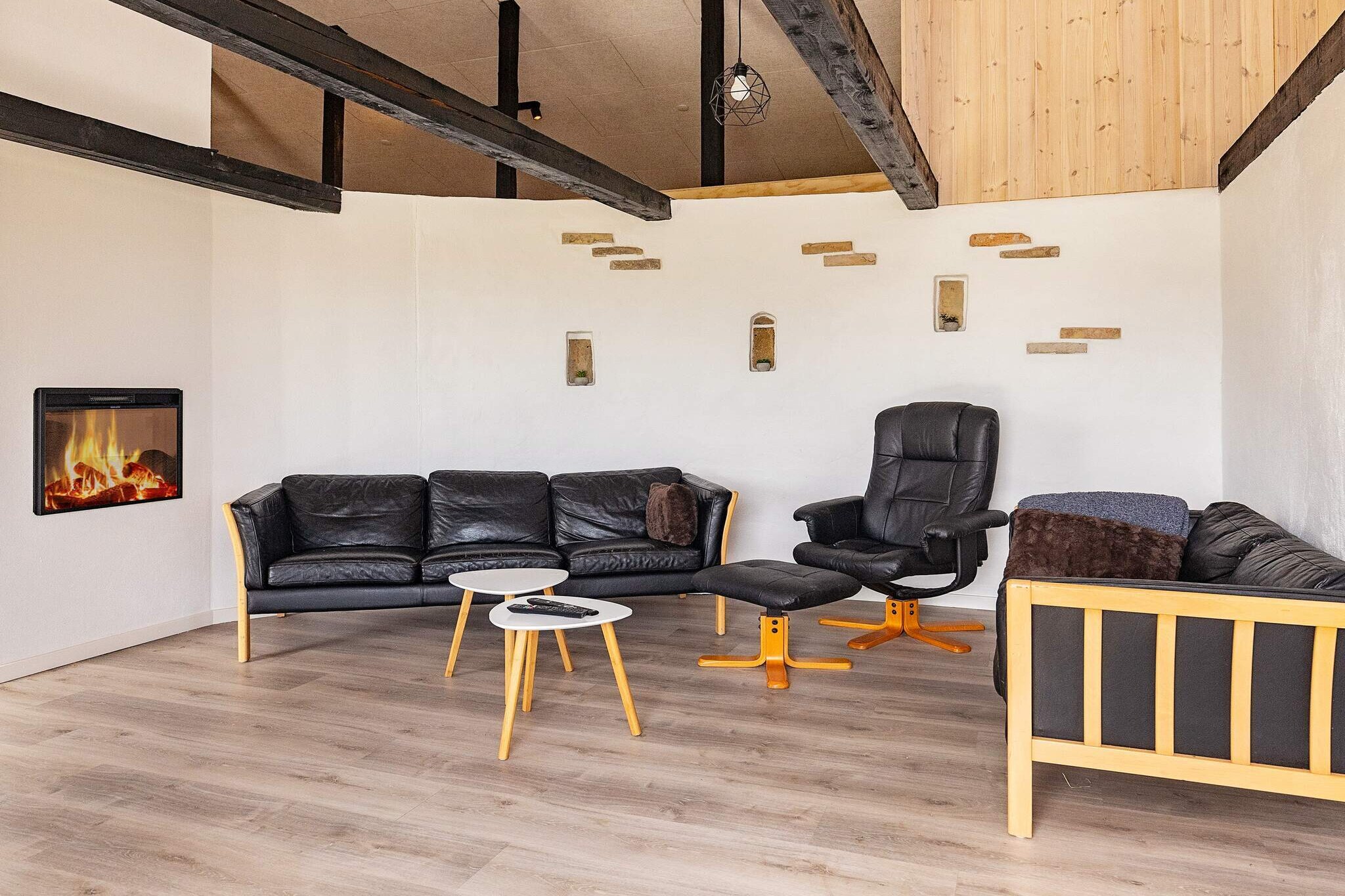 Energy-efficient cottage with wilderness bath located in scenic Thy. The plot is 2000 m² and in peaceful surroundings close to forest and fishing park. Rainbow trout and brown trout are stocked in the lake. The owner of the summer house was responsible for the extensive renovation in 2023, which was carried out with respect for the original farmhouse from around 1900. The house has high ceilings, and the large windows provide beautiful light to the kitchen/family room and living room. The TV room has an electronic fireplace. The living room is divided into two sections, and the rear section has a bar and pool table where you can play billiards, table football, and air hockey. All common rooms and bathrooms have underfloor heating. The three bedrooms have electric radiators. Two bedrooms have double beds and the third has two single beds that can be pushed together to form a double bed. The large loft has six beds with spring mattresses, best suited for children. However, the stairs up to the loft are easy to climb. The two bathrooms are equipped with showers and comfortable underfloor heating, and one has a washing machine and dryer. The kitchen has ceramic hobs and two ovens, one of which also functions as a microwave. The freezer is in the hallway. There is a large, open wooden terrace by the house, where you will also find the wilderness bath and gas grill.Not available for rent to youth groups or construction crews.A refundable deposit might be charged closer to your check-in date. The security deposit ensures a smooth stay and covers any additional services or consumption charges.This deposit covers utilities consumed during your stay and any additional services that may be taken.The final amount will be adjusted based on actual meter readings, actual usage of extra services, and any remaining balance will be refunded within 21 days after checkout.This deposit simply acts as a prepayment for charges that  you would anyways pay for, ensuring a seamless stay and check-out experience.