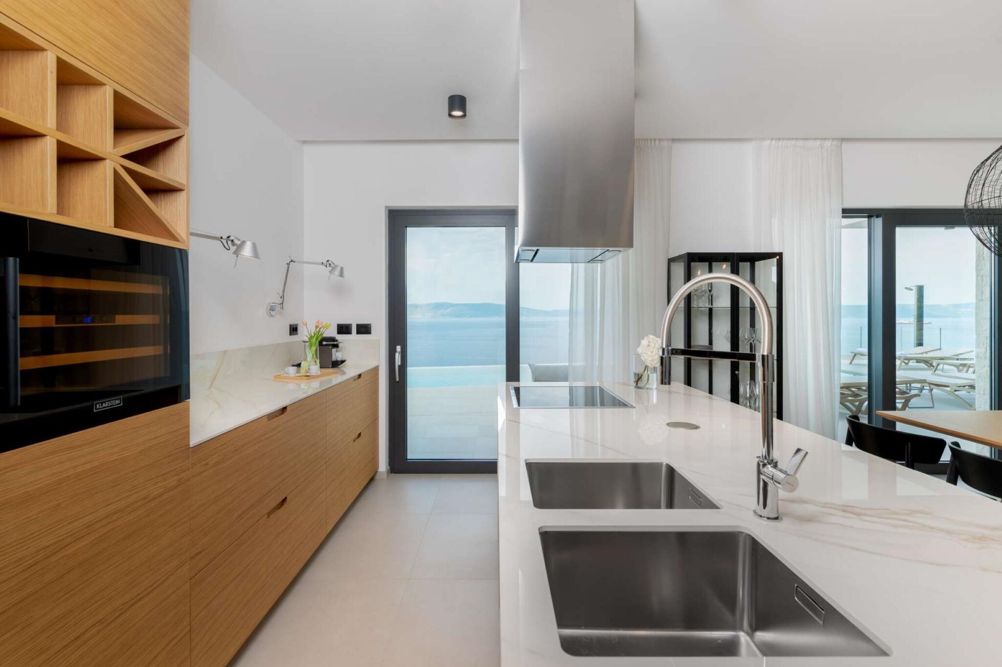 Ground floor: (Living room(TV, streamingservice), dining room(seating area), Kitchen(stove, electric kettle, toaster, coffee machine, oven, combination microwave, dishwasher, freezer), fitness room(sauna, fitness equipment), air conditioning)\n\nOn the 1st floor: (bedroom(double bed), bedroom(double bed), bedroom(double bed), bedroom(double bed), bathroom(shower, toilet), bathroom(shower, toilet), bathroom(shower, toilet), bathroom(shower, toilet), recreation room, air conditioning)\n\noutdoor kitchen, roof terrace, garden, parking, private outdoor pool