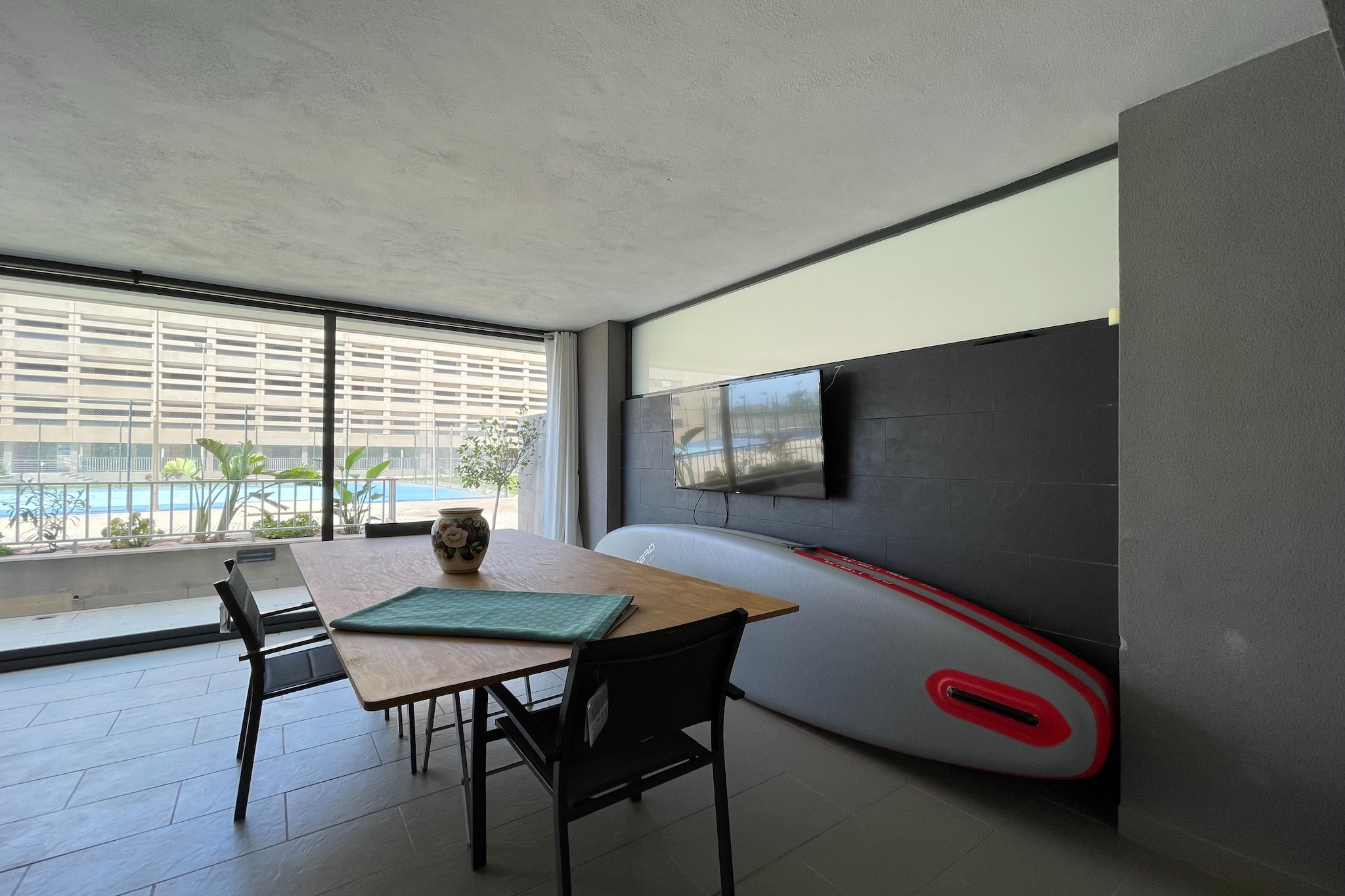 Ground floor: (Entrance(shared with other guests), open kitchen(hob, electric kettle, hood, coffee machine, oven, fridge-freezer), Living/diningroom(double bed(180 x 200 cm), TV(flatscreen), seating area), bedroom(double bed(135 x 200 cm)), bedroom(single bed(110 x 190 cm), single bed(90 x 190 cm)), bathroom(bathtub with shower, washbasin, toilet, bidet), heating, air conditioning, terrace(private, 25 m2), garden furniture)\n\nfitness room(fitness equipment(shared with other guests)), parking lot(public), swimming pool(shared with other guests, outside, opened from May upto and including Sep), swimming pool(shared with other guests, indoor, opened from Jan upto and including Dec), tennis court(shared with other guests), padel court