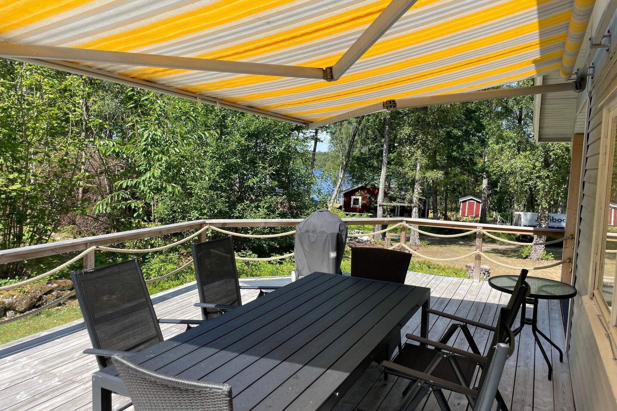 Lovely holiday house in Backaryd, 70m from nice swimming at the private swimming area that belongs to the house. Here you live close to the lake with the forest as a neighbor and at the same time you are close to the coast with only 15 km to Ronneby and 40 km to Karlskrona. You have a large garden with a wonderful covered veranda with lovely lounge furniture and a lake view. You also have a larger patio deck in connection where there are sun loungers, dining furniture and a barbecue. In the fresh, cozy house there is a spacious living room with a comfortable corner sofa and TV with Chromecast in front of the stove. The stove gives lovely heat and has a high coziness factor, but should be handled carefully and only by experienced users, follow instructions carefully. In the kitchen there is a dining area and most of what you might need. You have two nice bedrooms with comfortable beds, one with a 140 cm wide bed, the other with two single beds. The bathroom is newly renovated and fresh with toilet, sink and shower. You have a rowing boat to explore the lake or take a fishing trip with. The boat is located down by the nice swimming area with jetty. Life jackets are available. The house and its surroundings invite you to wonderful nature experiences in all seasons, perhaps grilling sausages by the beach on a sunny winter's day and if the ice is thick, a walk or fishing trip on it. At the back of the house there is a trampoline for the children. In Ronneby and Karlskrona there is a wide range of culture, nice bathing spots, restaurants and shopping. From here you can also take boat trips out into the archipelago among cobs and skerries. The house is located 50m from a busy road. Firewood is included in limited quantities. Pets are not welcome.