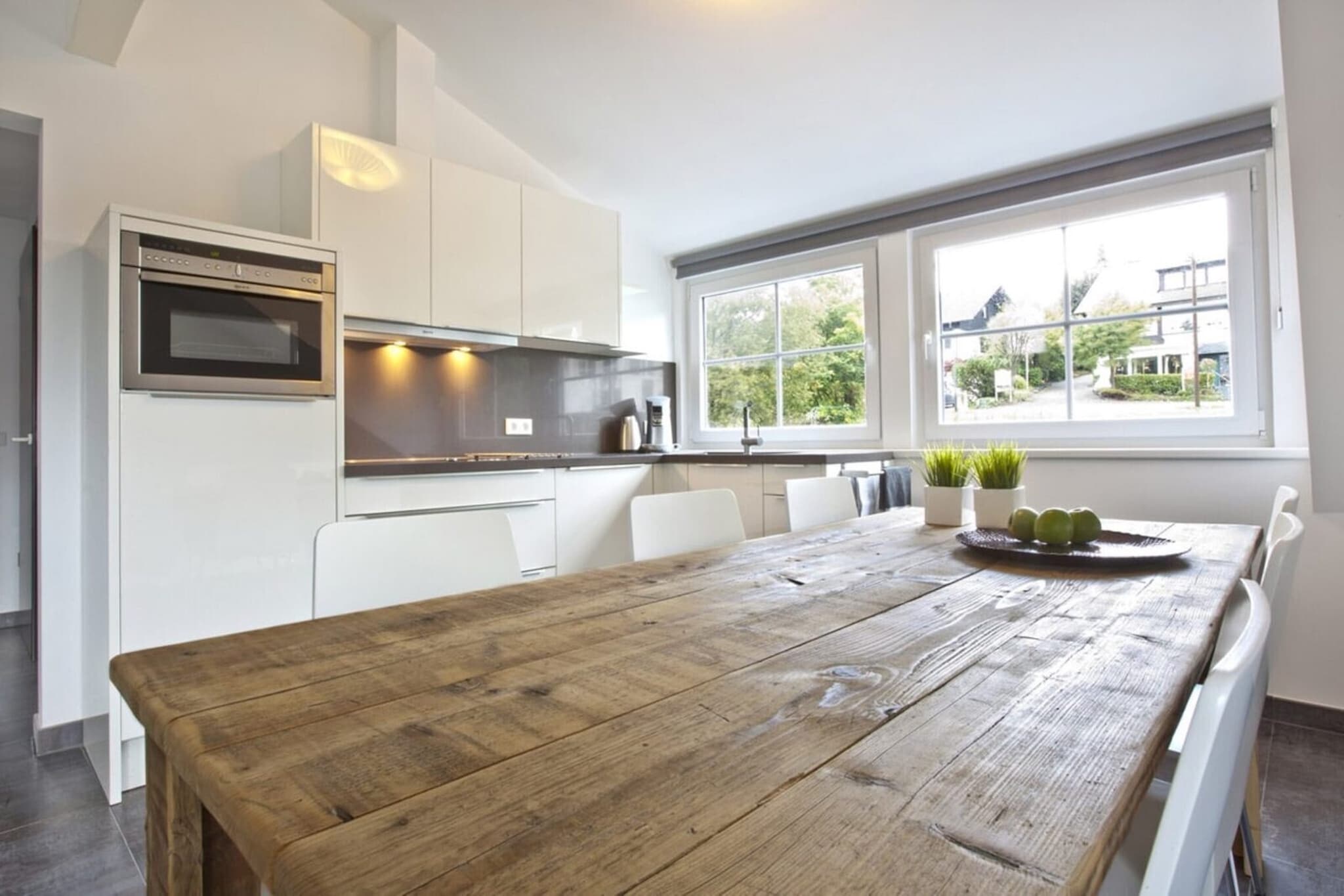 On the 2nd floor: (open kitchen(electric kettle, cooker(ceramic, electric), coffee machine(cups), oven, combination microwave, dishwasher, fridge-freezer), Living/diningroom(TV, dining table, seating area), bedroom(double bed), bedroom(bunk bed), bathroom(shower, washbasin, toilet, hairdryer), Landing)\n\ncot, terrace, garden furniture, parking, trampoline, table football, high chair, party games, Swing set