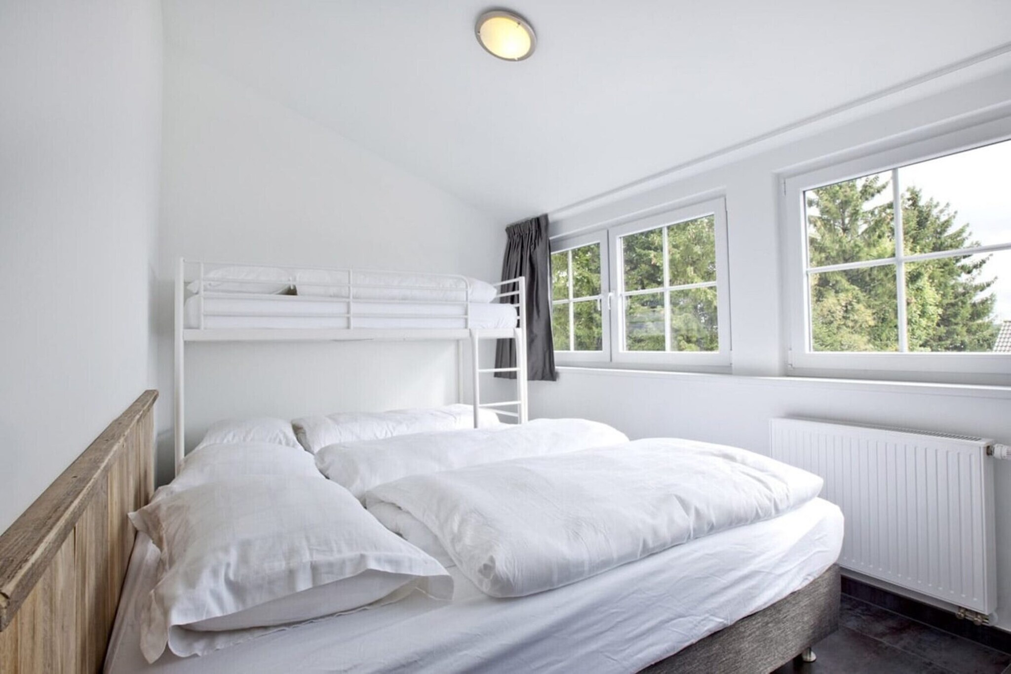 On the 2nd floor: (open kitchen(electric kettle, cooker(ceramic, electric), coffee machine(cups), oven, combination microwave, dishwasher, fridge-freezer), Living/diningroom(TV, dining table, seating area), bedroom(double bed), bedroom(double bed, bunk bed), bathroom(shower, washbasin, toilet, hairdryer), Landing)\n\ncot, balcony, garden furniture, parking, trampoline, table football, high chair, party games, Swing set