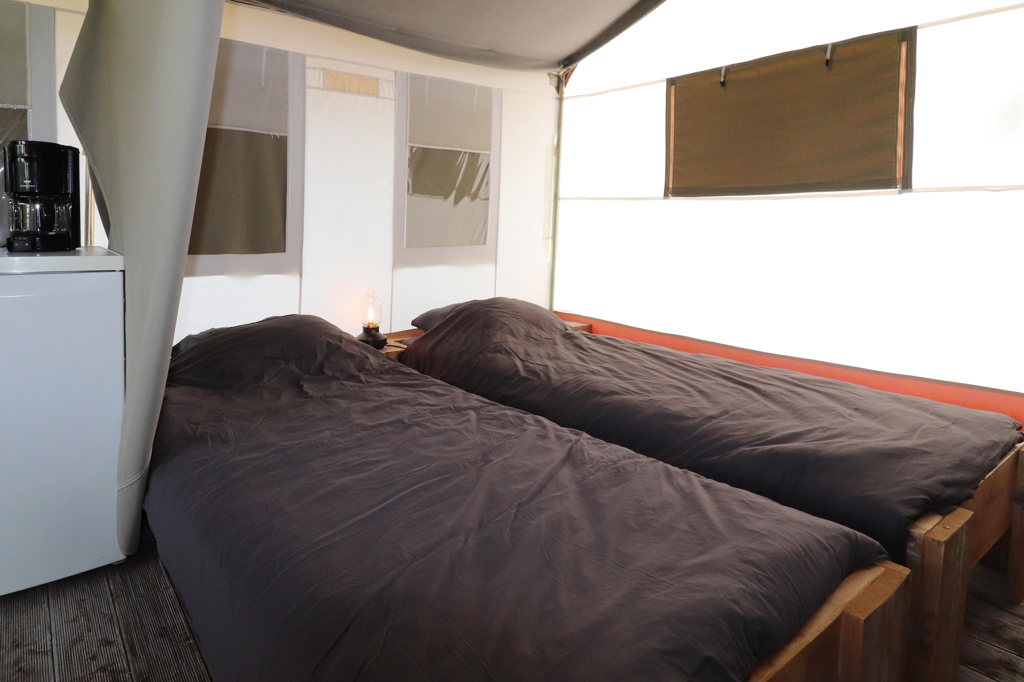 Ground floor: (Living room(dining table, seating area), Kitchenette(hob, electric kettle, coffee machine, fridge), bedroom(double bed), bedroom(single bed, single bed), bathroom(shower, washbasin, toilet))\n\nterrace, garden, garden furniture, deckchairs