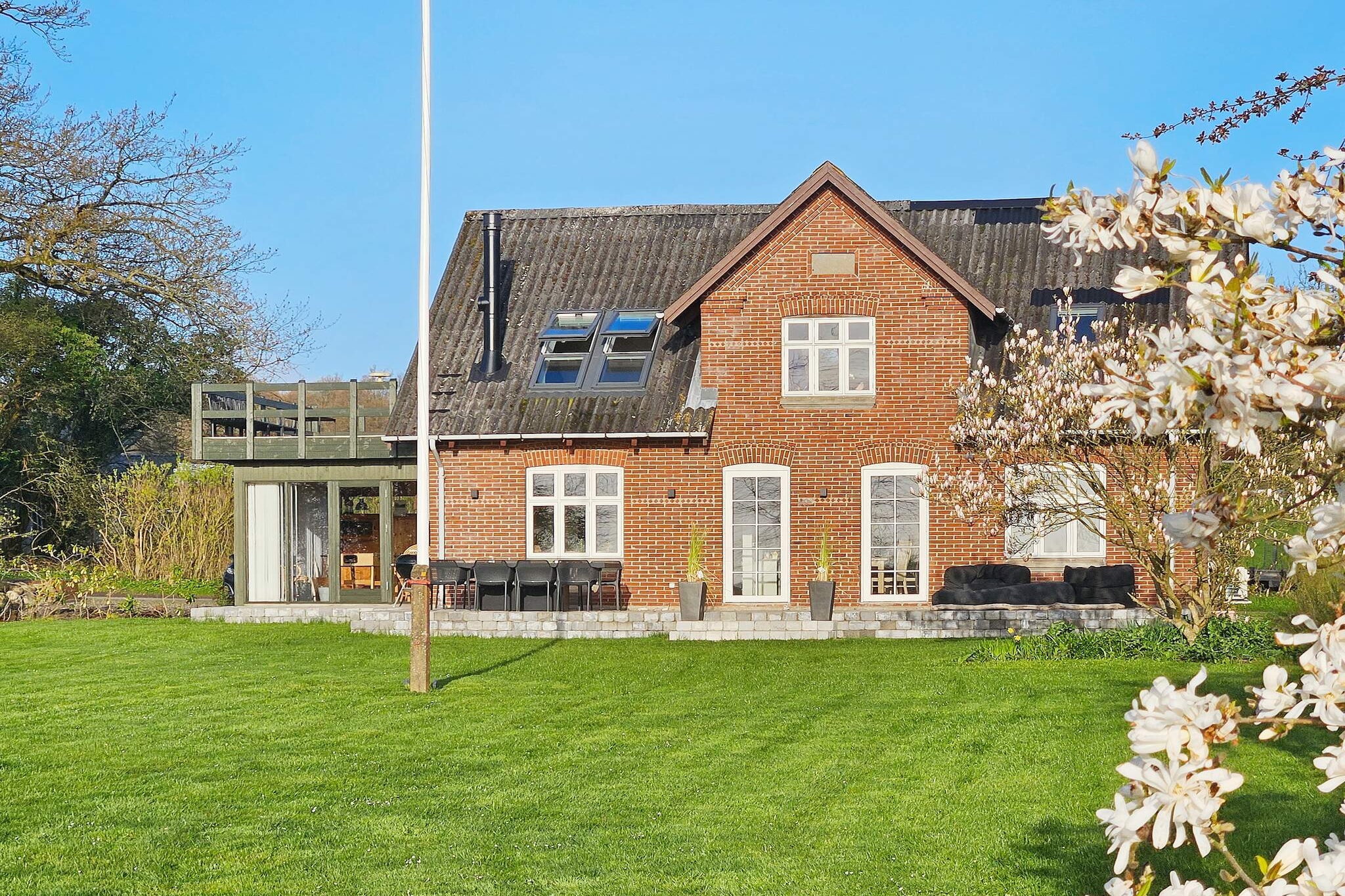In Binderup, you will find this summer house, which has been completely renovated for the summer of 2023. There is a fantastic view of the water and the Little Belt.

The ground floor of the vacation home features a large and bright kitchen/family room, which opens directly onto the conservatory/activity room. Here you can enjoy games and play for hours on end.

On the first floor, there is also a living room with the most beautiful view of the water. Both on the ground floor and on the first floor, there are two bedrooms and a bathroom. All of the cottage's bedrooms are located at a good distance from each other, making it easy to divide up the rooms. There is a wood-burning stove in the house.

On the first floor, you also have access to the lovely, large balcony. Here, you are also invited to spend many hours enjoying the beautiful view.

Outdoor life is also something quite special. Here you can enjoy the huge garden and the lovely terrace area with a view of the water. The garden table is a so-called "fire table" where you can light it in the evening and enjoy the glow of the flames under the open sky. On the terrace, you will also find a comfortable lounge set that invites you to relax.
There is entertainment for the whole family in the garden, where you can play croquet, ladder golf, and king's game.

 The house belongs to a family who have owned it for several generations. Out of respect for this, they have renovated the house for the summer of 2023. The vacation home is located a short distance from the child-friendly beach in Binderup. Not available for rent to youth groups.