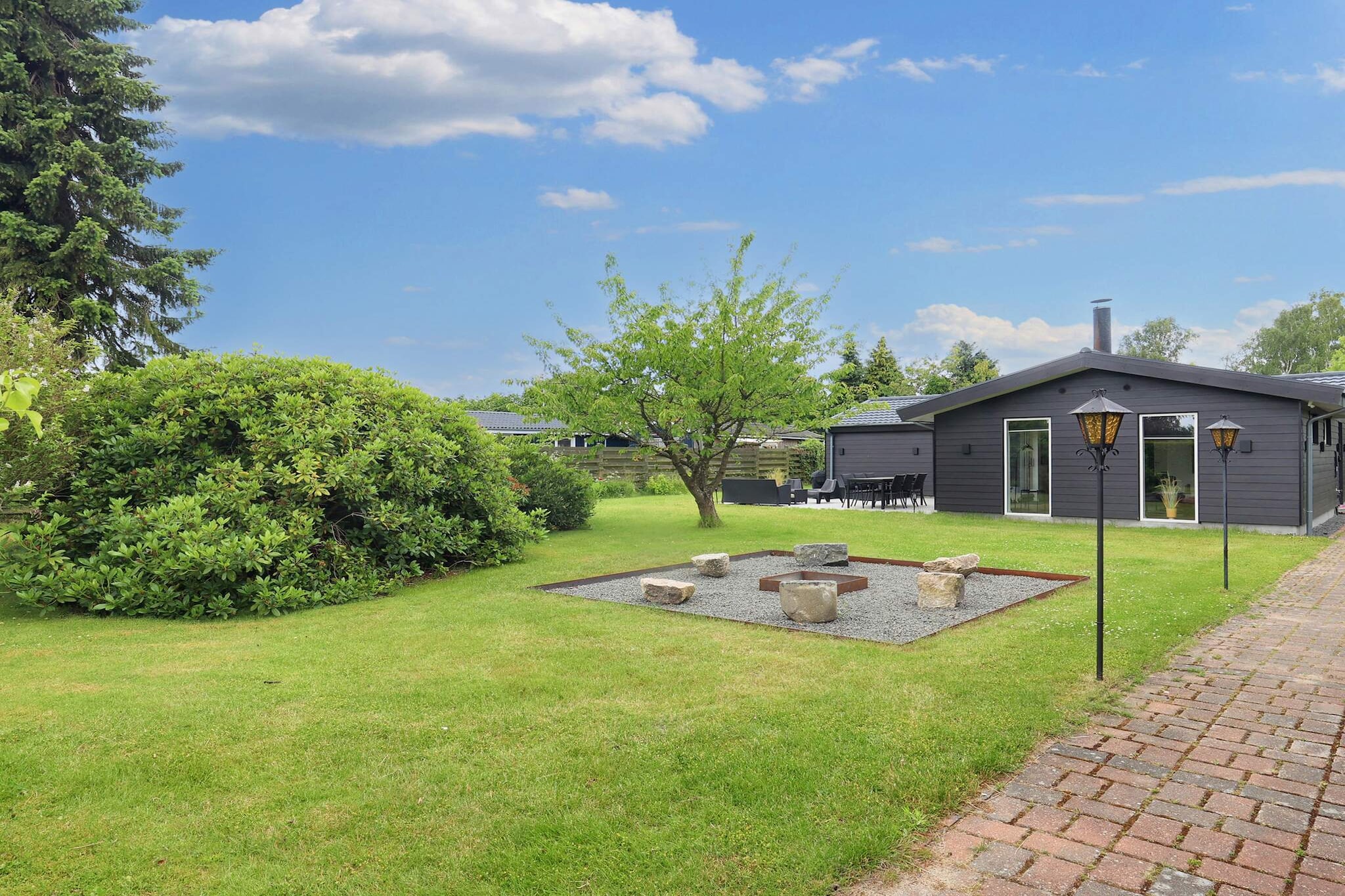 A stone's throw from Marielyst town center, shopping, restaurants, experiences, and one of Denmark's best beaches, this renovated cottage is located at the end of a quiet and closed road. The spacious cottage with indoor spa bath invites you to enjoy many wonderful and cozy moments. The house has two bedrooms with double beds (one of which can be divided into two single beds) and one bedroom with two single beds. In the living room, there is a single bed on a daybed. The house's large bathroom offers, in addition to a toilet and shower with rain shower, a 2-person spa bath. There is another bathroom in the house, with a toilet and shower with rain shower. The kitchen is open plan and includes modern appliances such as a Quooker, a 90 cm induction hob, dishwasher, built-in oven, extractor hood, refrigerator, and freezer. The living room is bright with large sliding doors leading to the house's large terrace and includes a 72 smart TV, wood-burning stove, various games, and a large sofa for relaxing. If you have small children, there are a few toys in the house and a pull-along wagon for free use. The house is insulated for year-round use and has an air-to-air heat pump with cooling for hot summer days. In addition, there is underfloor heating in both bathrooms and a wood-burning stove in the large living room. The house is connected to fiber optic internet, so if you feel like streaming to the house's TV, there is plenty of speed. Outdoors, there are two nice terraces where you can enjoy the sun and peace, barbecue (charcoal grill), and relax.There is a lounge set, two sun loungers, and a dining table with chairs spread across the terraces. On cooler or rainy days, the house's bright conservatory can be used to extend and enjoy both summer and winter evenings in the sofa group or around the dining table. The house has a lovely garden with grass in various areas (sown in autumn 2023). Enjoy the large fire pit in the garden when you want to gather around the fire. Due to the house's quiet location, deer and hares often stop by. Not available for rental to youth groups.A refundable deposit might be charged closer to your check-in date. The security deposit ensures a smooth stay and covers any additional services or consumption charges.This deposit covers utilities consumed during your stay and any additional services that may be taken.The final amount will be adjusted based on actual meter readings, actual usage of extra services, and any remaining balance will be refunded within 21 days after checkout.This deposit simply acts as a prepayment for charges that  you would anyways pay for, ensuring a seamless stay and check-out experience.