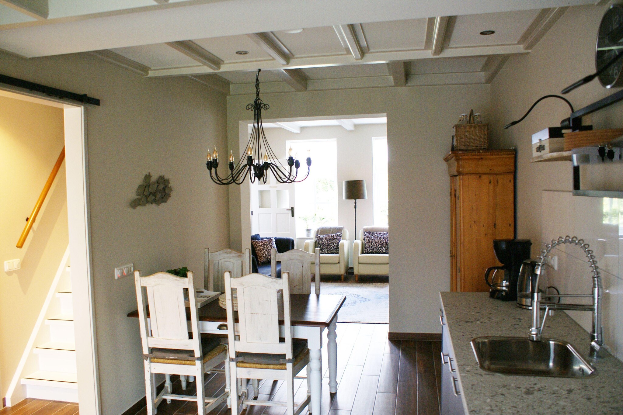 Ground floor: (hallway, hallway, hallway, Living room(TV, decorative fireplace, seating area), Living room(TV, decorative fireplace, seating area), Living room(TV, decorative fireplace, seating area), Kitchen(hob(induction), electric kettle, coffee machine(filter), coffee machine(pads), oven, microwave, dishwasher, fridge(+ freezer)), Kitchen(dining table, hob(induction), electric kettle, coffee machine(filter, pads), oven, microwave, dishwasher, fridge), Kitchen(hob(induction), electric kettle, coffee machine(filter, pads), oven, microwave, dishwasher, fridge), bedroom(double bed), bedroom(double bed), bathroom(shower, washbasin, washbasin, toilet, washing machine), bathroom(shower, washbasin, washbasin, toilet), bathroom(shower, washbasin, toilet), toilet(toilet), toilet, toilet, pantry, pantry)\n\nOn the 1st floor: (bedroom(double bed), bedroom(single bed, single bed), bedroom(double bed), bedroom(double bed), bedroom(double bed))\n\nwashing machine, garden doors, terrace, garden, garden, garden furniture, parking, parking lot(public), party games, insect screens, Charging post for electric cars