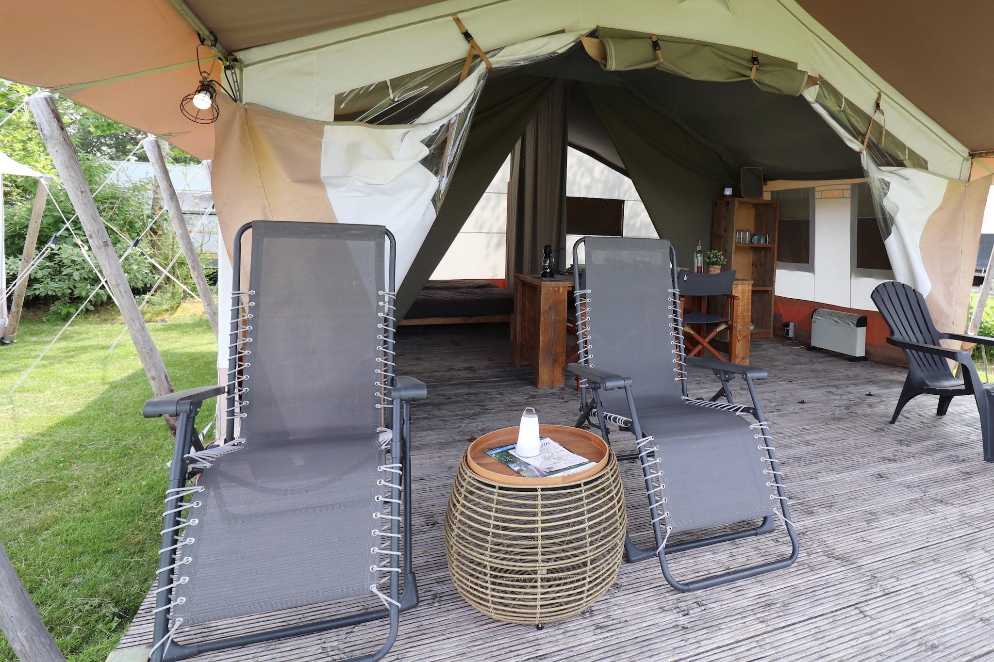 Ground floor: (Living room(dining table, seating area), Kitchenette(hob, electric kettle, coffee machine, fridge), bedroom(double bed), bedroom(single bed, single bed), bathroom(shower, washbasin, toilet))\n\nterrace, garden, garden furniture, deckchairs