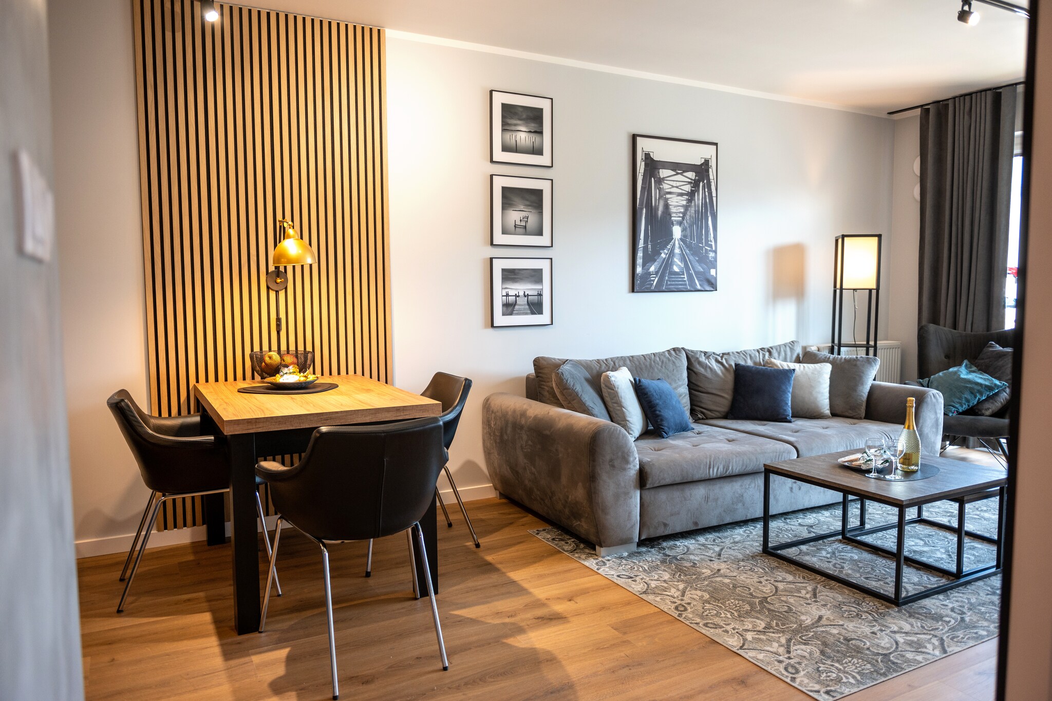 Apartment complex directly on the banks of the Dziwna River. In addition to accommodation, it offers a SPA zone with an indoor pool, whirlpool and sauna. Only 700 m to the beach. About 250 m to the resort center.
The comfortable apartment offers comfortable accommodation on the second floor (there is an elevator). The apartment consists of a living room combined with a well-equipped kitchen, a double bedroom and a bathroom with a shower (there is a washing machine). The living room has a double sofa bed, a table and TV. The apartment has a large, covered terrace with a set of garden furniture. Central heating. Wireless internet available.
On the premises of the complex, guests have access to an indoor swimming pool (+ a paddling pool for children), a whirlpool, a sauna and a fitness room. Parking is available for those arriving by car.
The price of the stay includes: electricity and water consumption, swimming pool, sauna, whirlpool, fitness room, parking space in the underground garage, internet. On request, a baby cot and a high chair.
Dziwnów has a clean, sandy and guarded beach, separated from the city by a strip of dunes. In the summer, children can use the water slide and inflatable structures for jumping. Wooden breakwaters protrude from the sea, on which seagulls often sit. An attraction is the walking promenade that stretches along the beach. A tourist attraction in Dziwnów is the drawbridge on the Dziwna River. It offers a view of the river. Its complicated steel structure, painted red, attracts attention from afar. The process of raising the bridge is very spectacular. In the local fishing port, you can buy fish straight from the cutter. There are also sales stands offering smoked fish and other fish products.