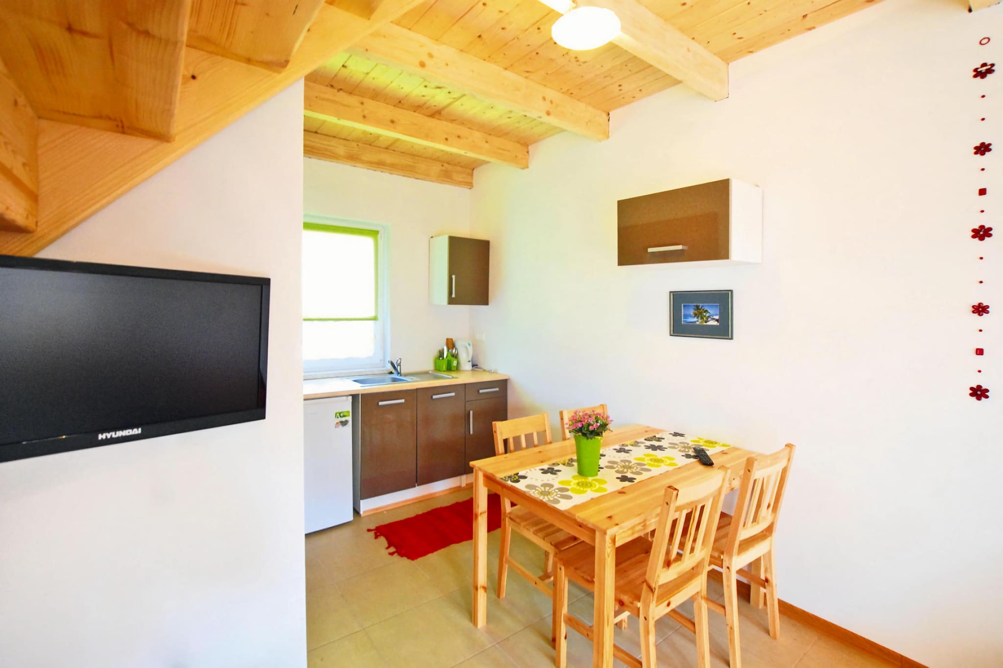 Ground floor: (open kitchen(hob(2 ring stoves, electric), electric kettle, coffee machine, microwave, fridge-freezer), Living/diningroom(double sofa bed, TV(flatscreen, satellite, german television channels), dining table(4 persons)), bathroom(shower, washbasin, toilet))\n\nOn the 1st floor: (bedroom(double bed), walk-through bedroom(single bed, single bed))\n\nReception, Internet access, Play area, Lawn, baby bath, heating(electric), terrace(roofed), garden(shared with other guests, fenced, 500 m2), garden furniture, sun loungers, BBQ(charcoal), parking, trampoline(shared with other guests), sand pit(shared with other guests), play equipment(shared with other guests), slide(shared with other guests), high chair, toys, Swing set, baby crib(free)