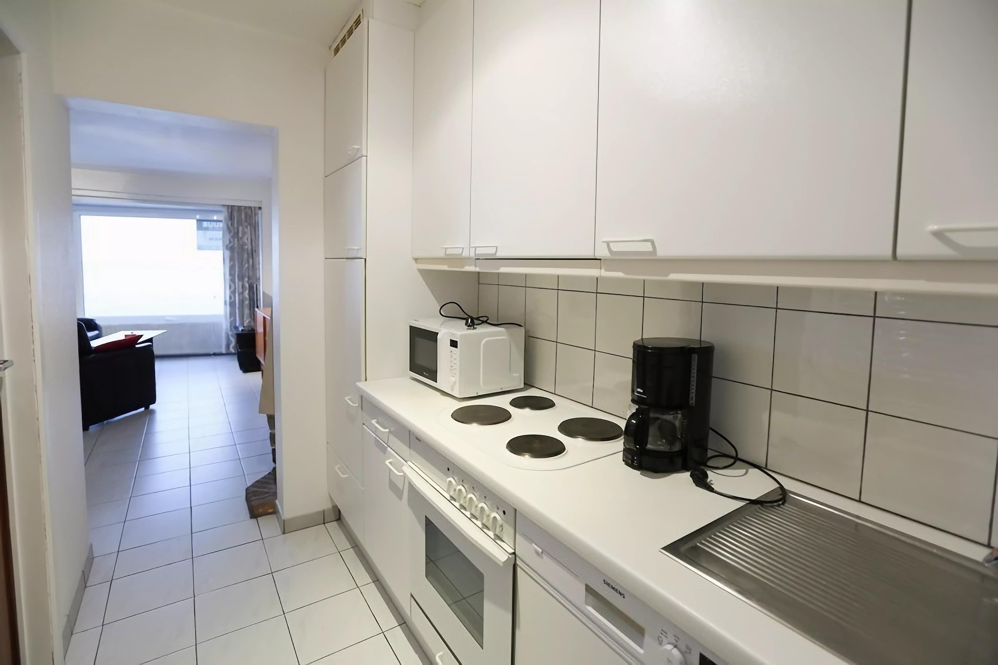 Coastal Comfort with Room to Breathe
Step into this spacious seaside apartment designed for comfort and convenience. Located on the 1st floor, it features two well-appointed bedrooms—one with a cozy double bed, the other with a double bed and two single beds—making it perfect for families or small groups. The bright living/dining area invites you to unwind with a movie or gather for a relaxed meal, while the modern kitchen comes fully equipped with everything from a hand blender to a dishwasher, ensuring stress-free cooking during your stay.

Prime Seafront Location
Nestled directly on the Zeedijk in Middelkerke, you’re just steps from the beach, where sunrises and sunsets over the water are your daily backdrop. This central location also places you close to shops, bakeries, the tram stop, and key attractions like Westgolf (5 km) or the vibrant town of Nieuwpoort (9 km). Whether you're in the mood for a beach stroll or a day trip to Bruges or Plopsaland, everything is within easy reach.

Savor Local Flavors Nearby
You’ll be spoiled for choice with restaurants and cafés lining the promenade just outside your door. From freshly baked croissants in the morning to seafood feasts at sunset, Middelkerke’s dining scene caters to every craving. Return to your peaceful, well-equipped retreat after a day of exploration.